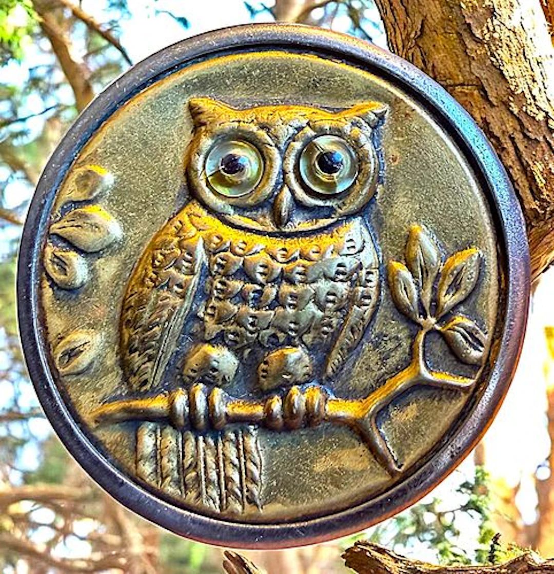 A DIVISION ONE GLASS EYED BIRD BUTTON