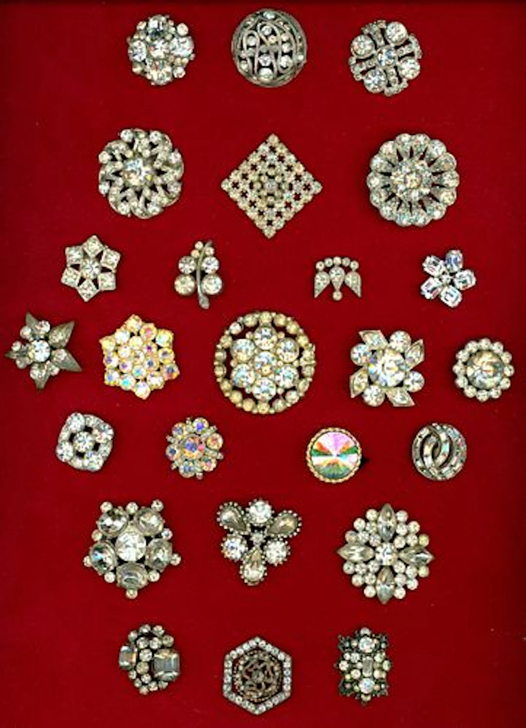 A CARD OF DIVISION ONE AND THREE JEWELED BUTTONS