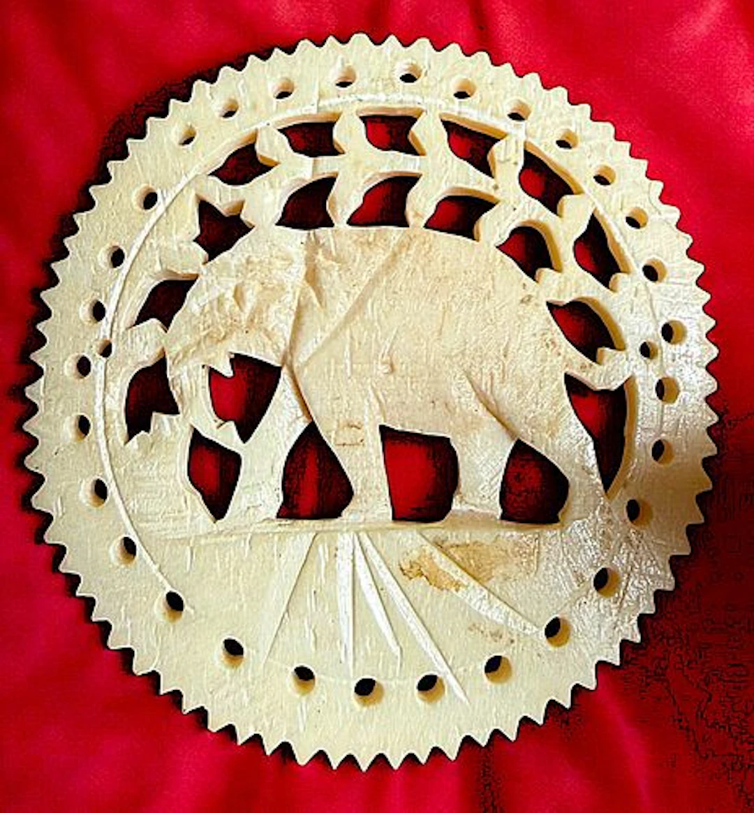 A DIVISION THREE PIERCED & CARVED ANIMAL BUTTON