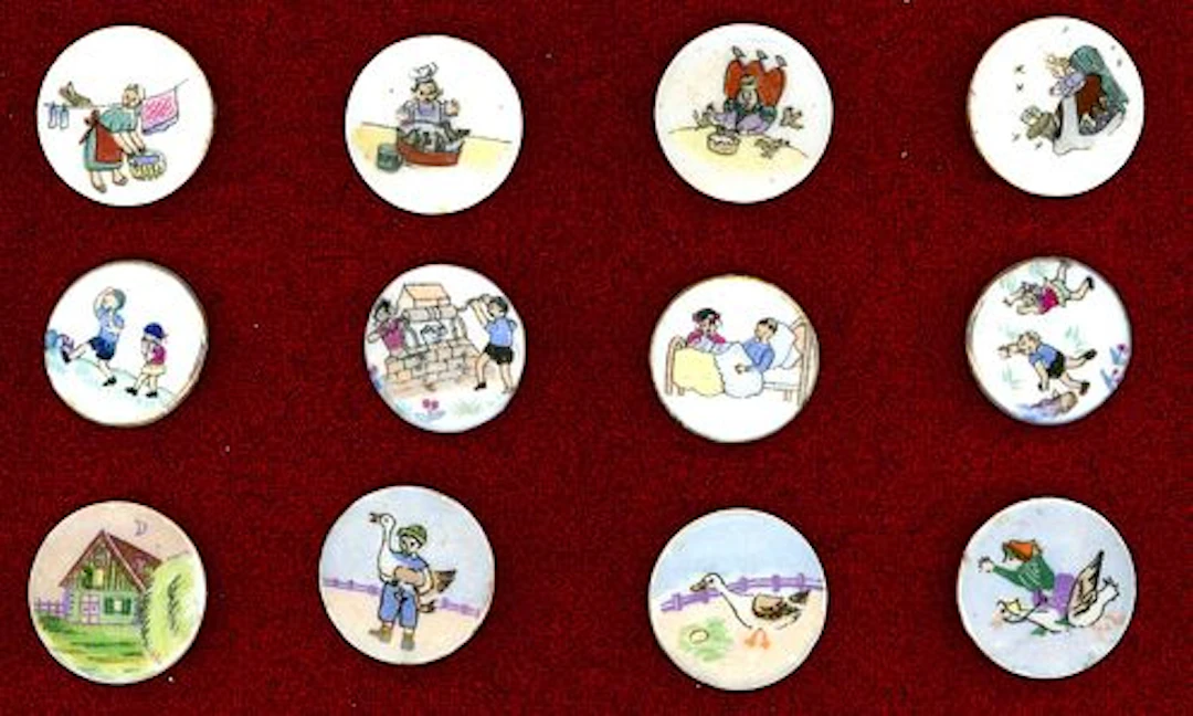 A SMALL CARD OF DIVISION THREE NURSERY RHYME BUTTONS