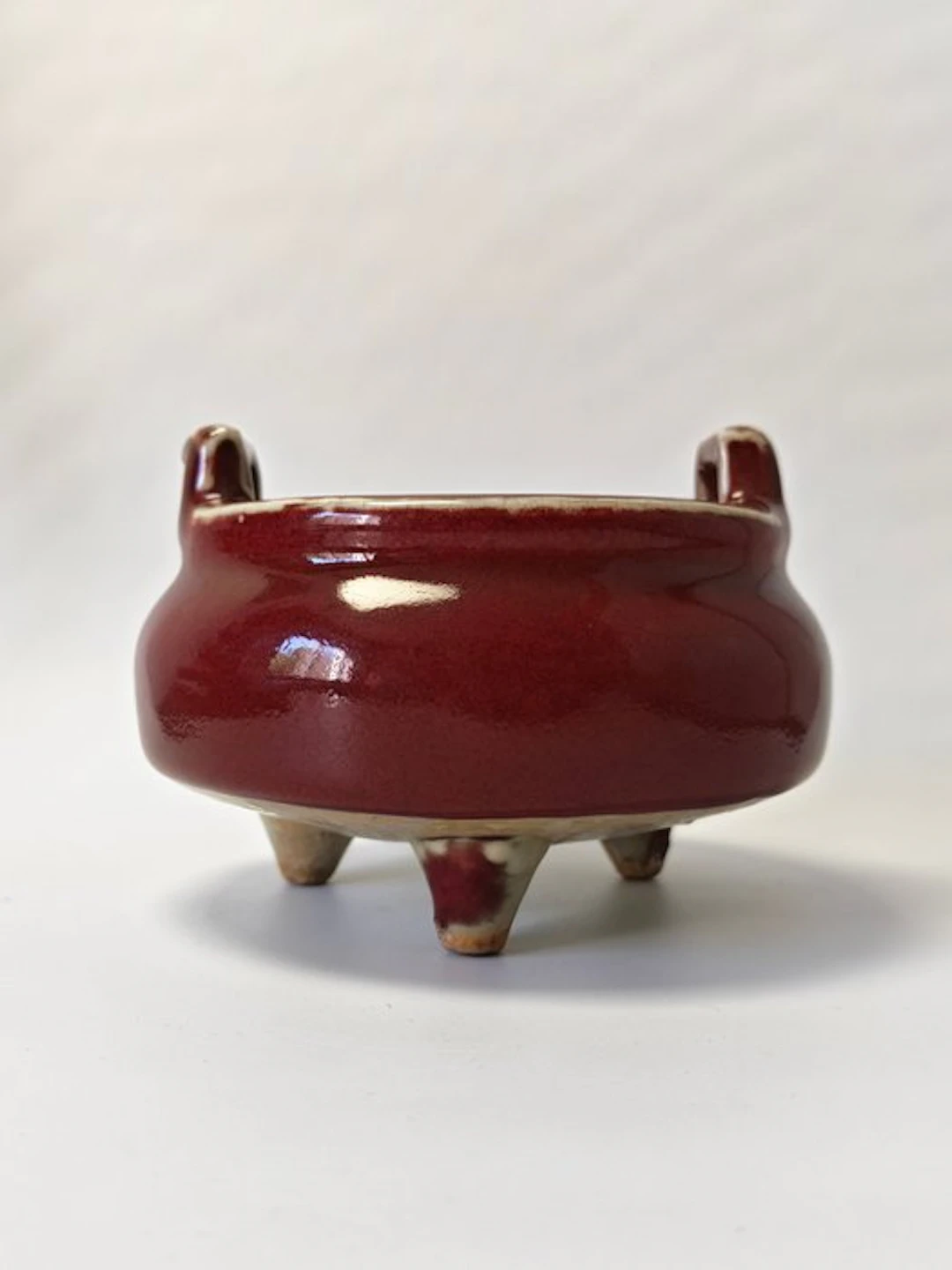 red glaze tripod censer with upright sky ears. - Ceramic - China - 20th century