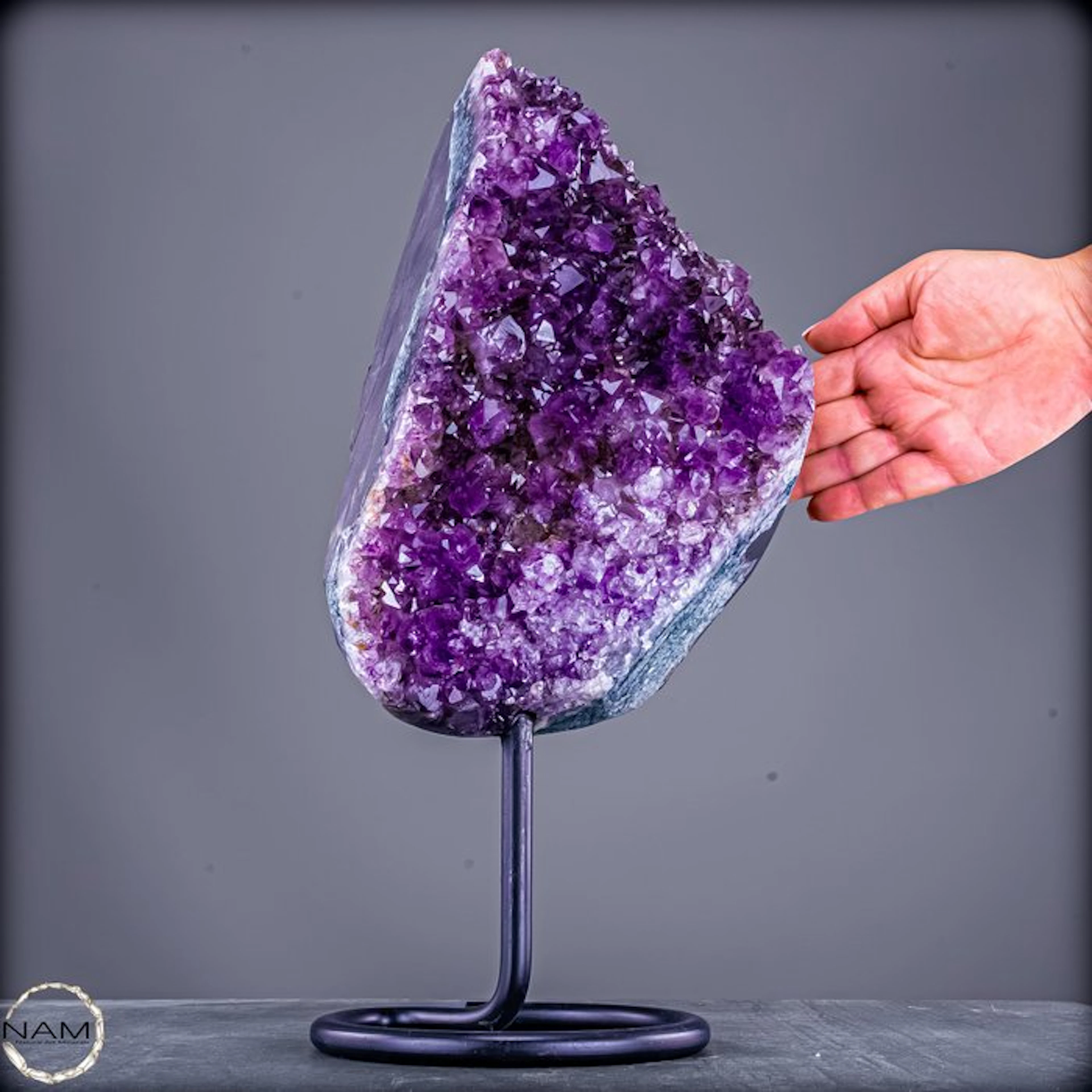 Radiant amethyst on a metal stand – elegance in violet splendor