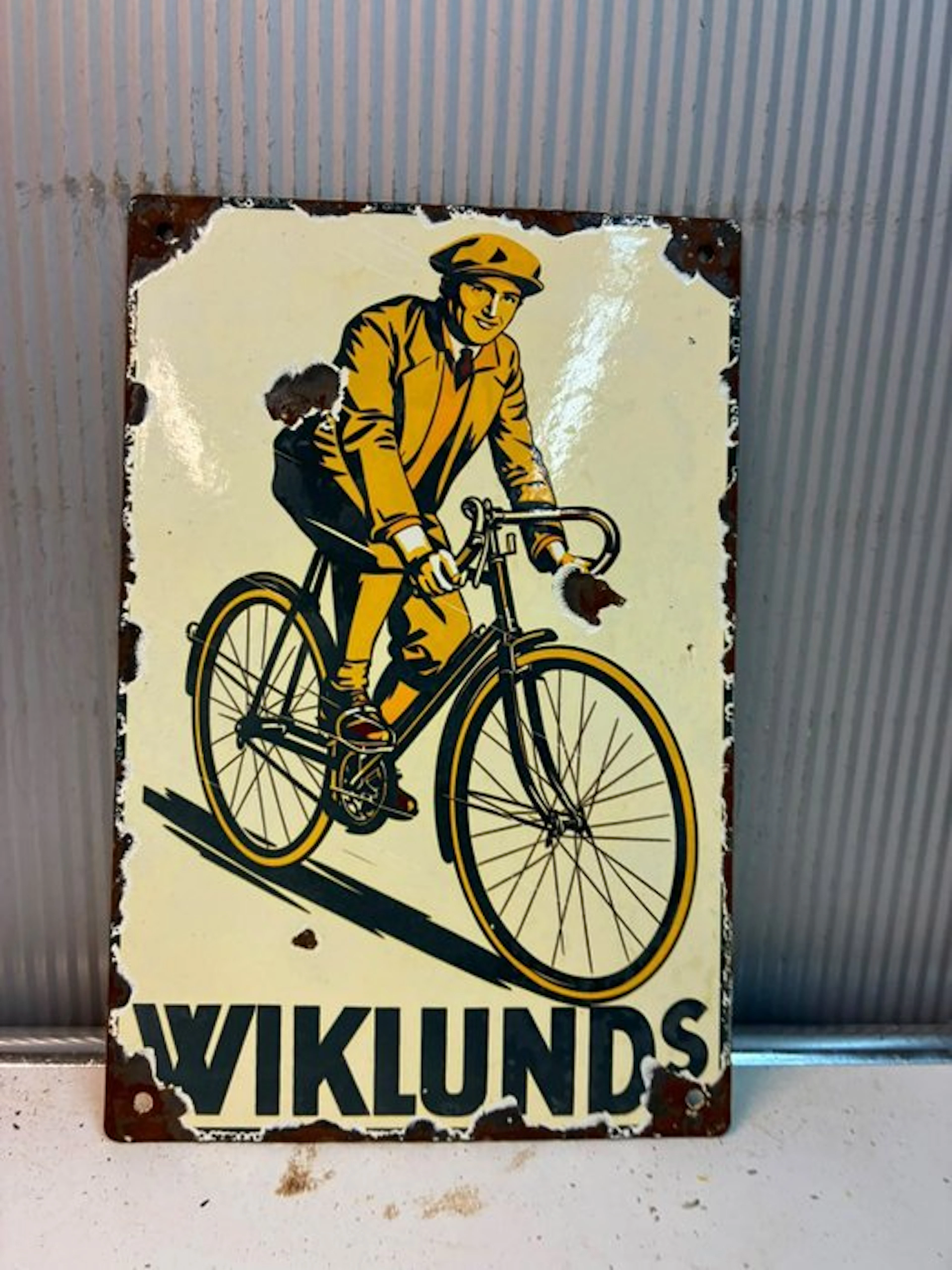 Wiklunds – enamel advertising sign featuring a cyclist - Enamel sign - Enamel