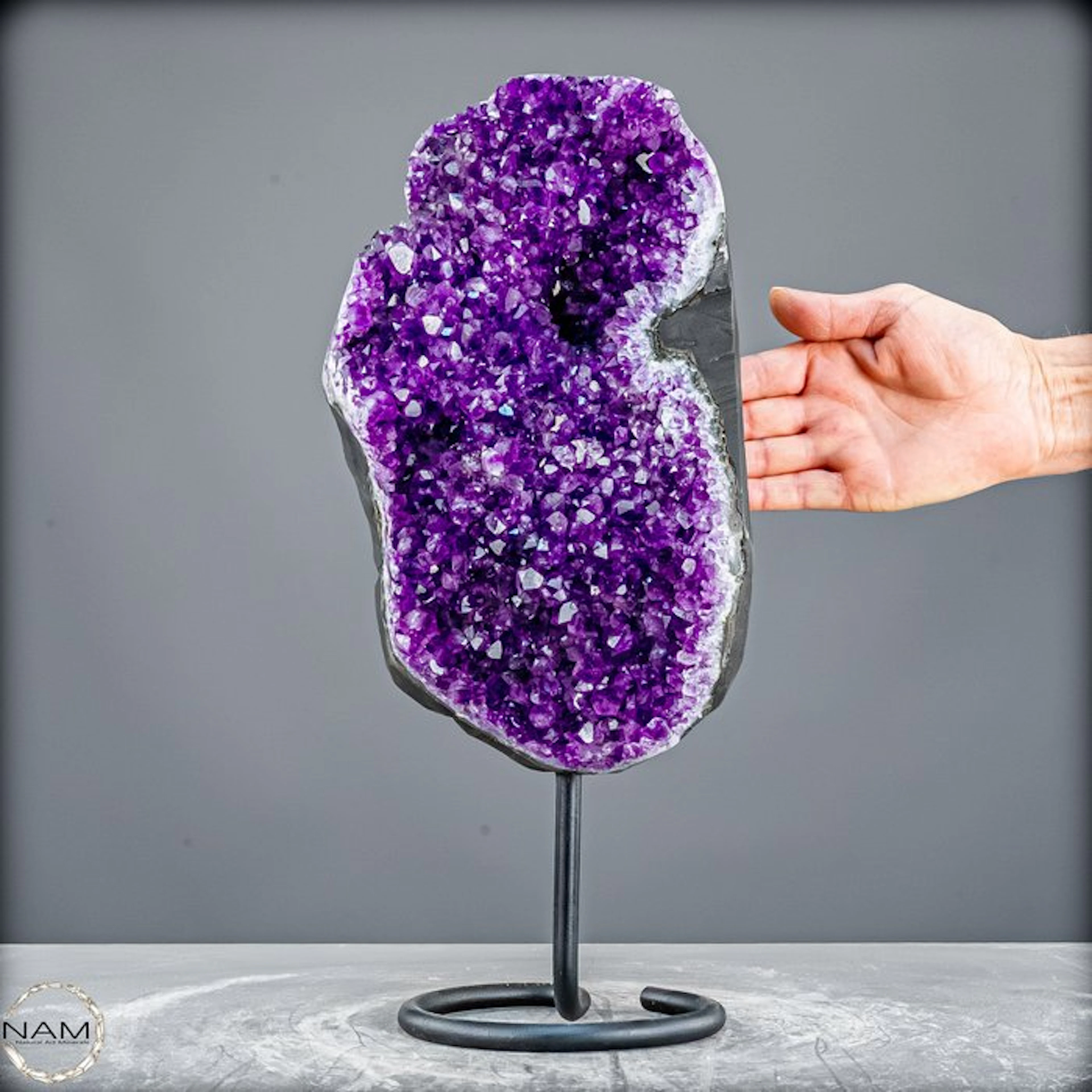 Radiant amethyst on a metal stand – elegance in violet splendor
