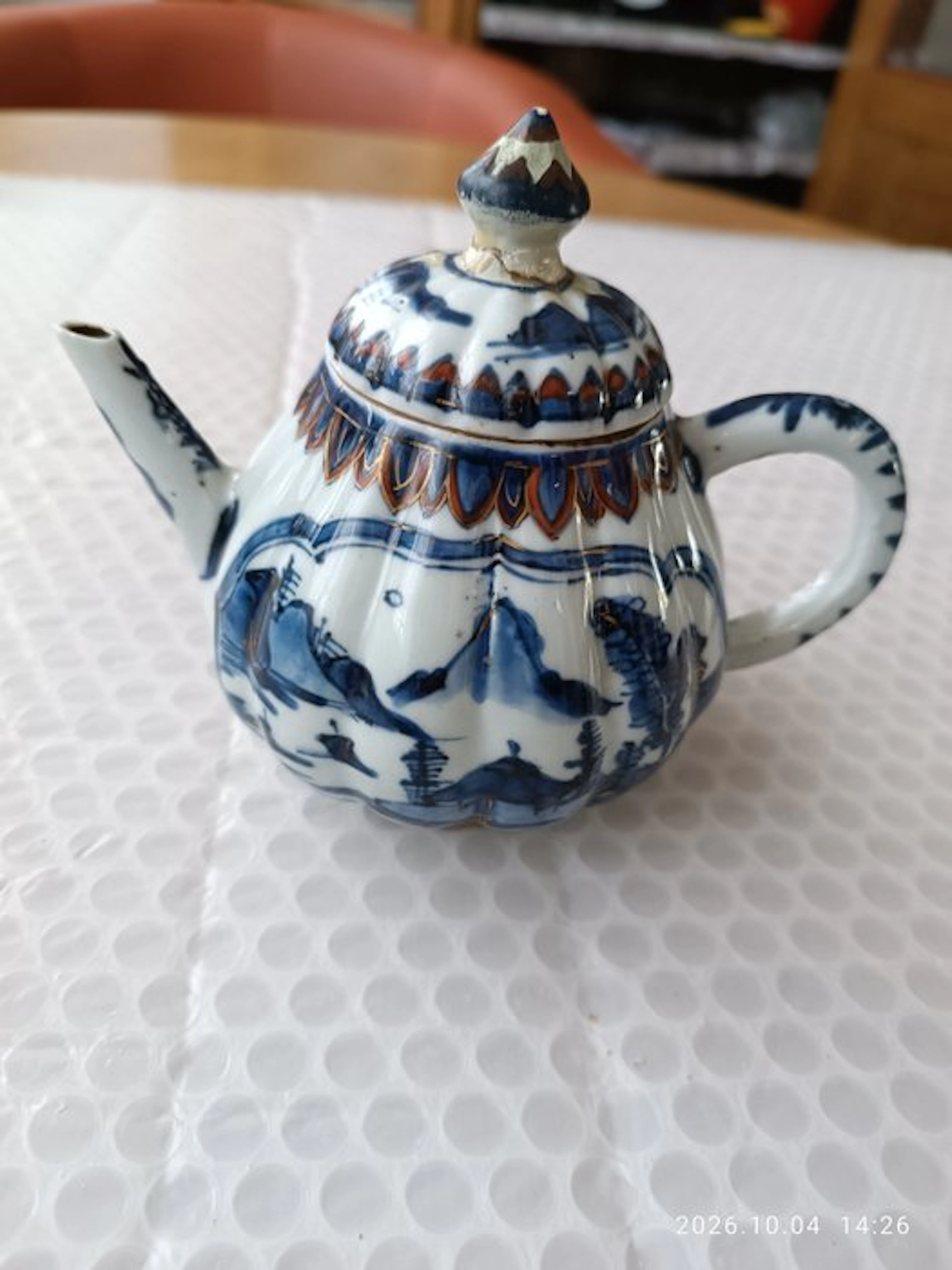 Chinese porcelain teapot with blue-and-white landscape...
