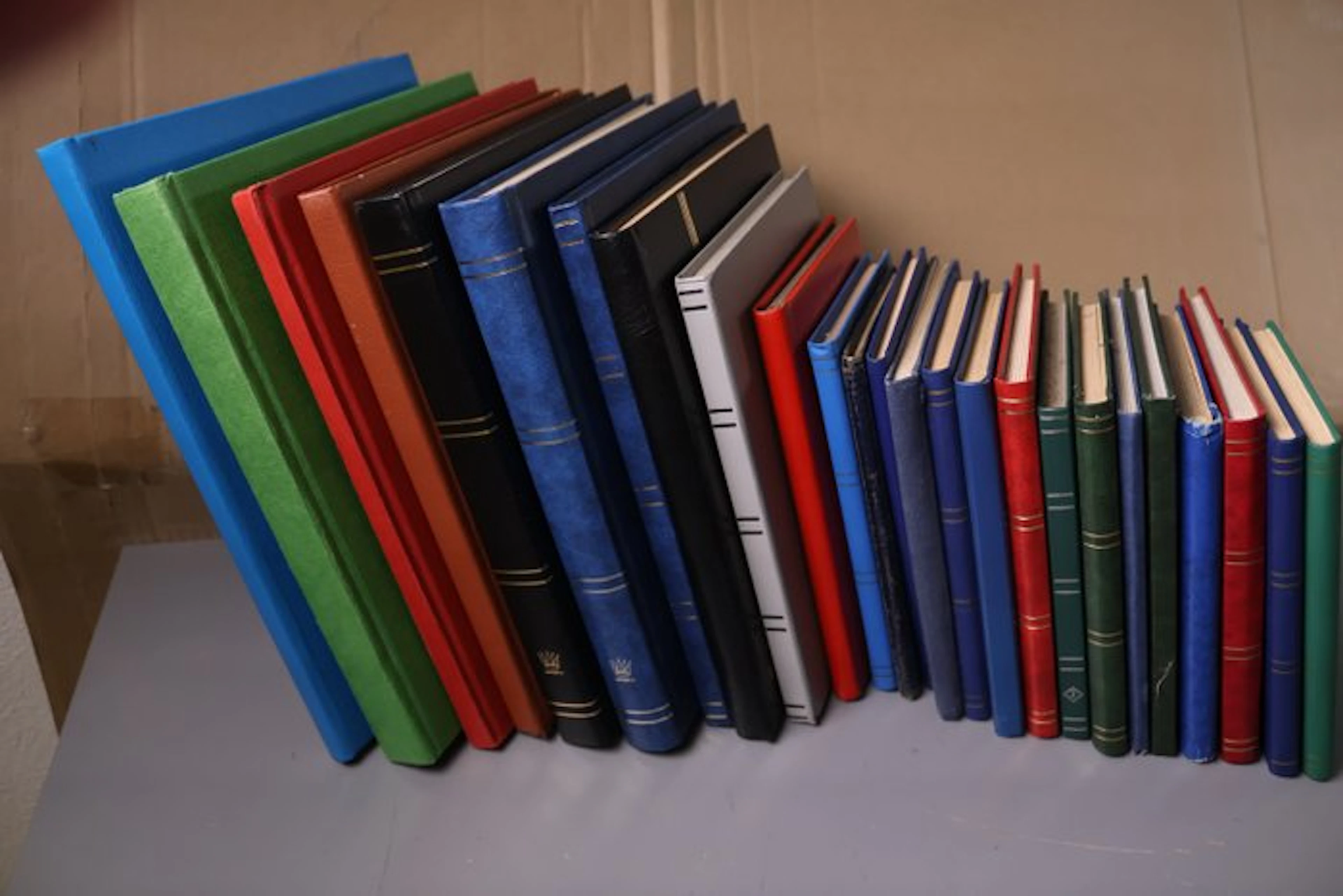 World - 25 empty stock books of various sizes with white pages.