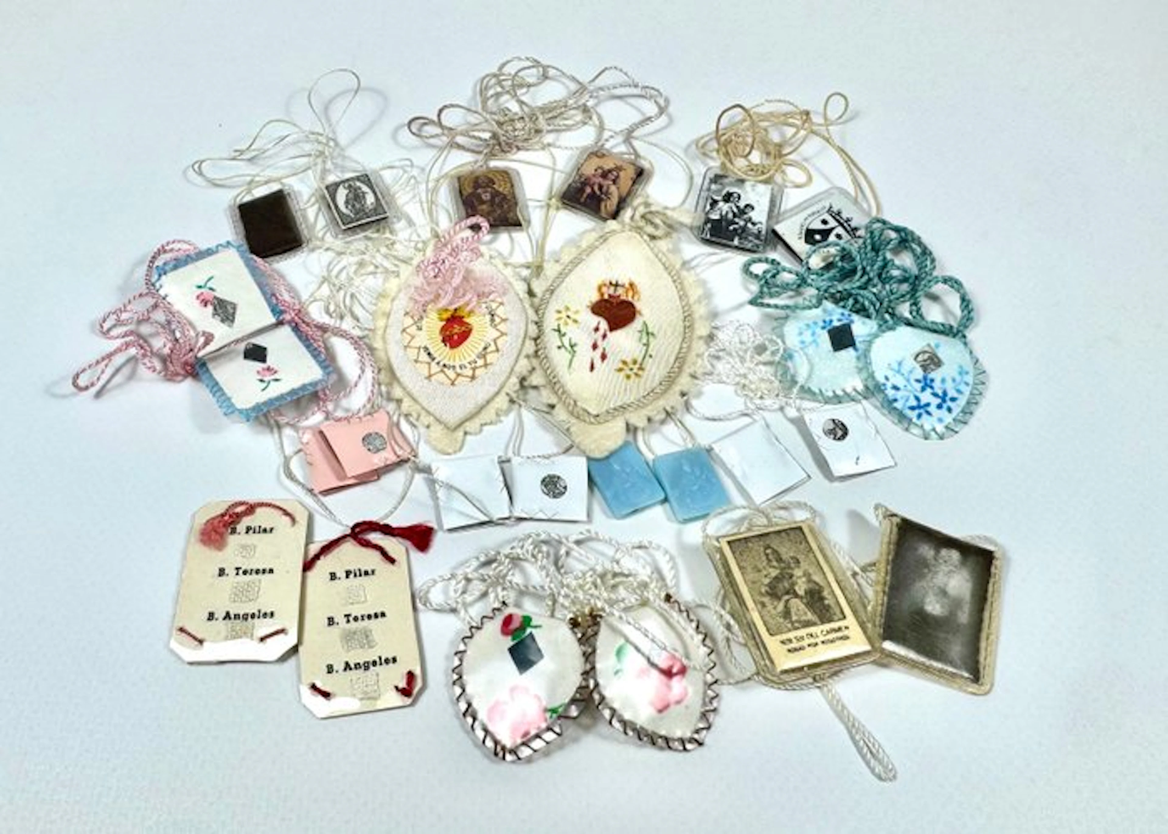 Collection of 14 antique scapulars with relics (14)...