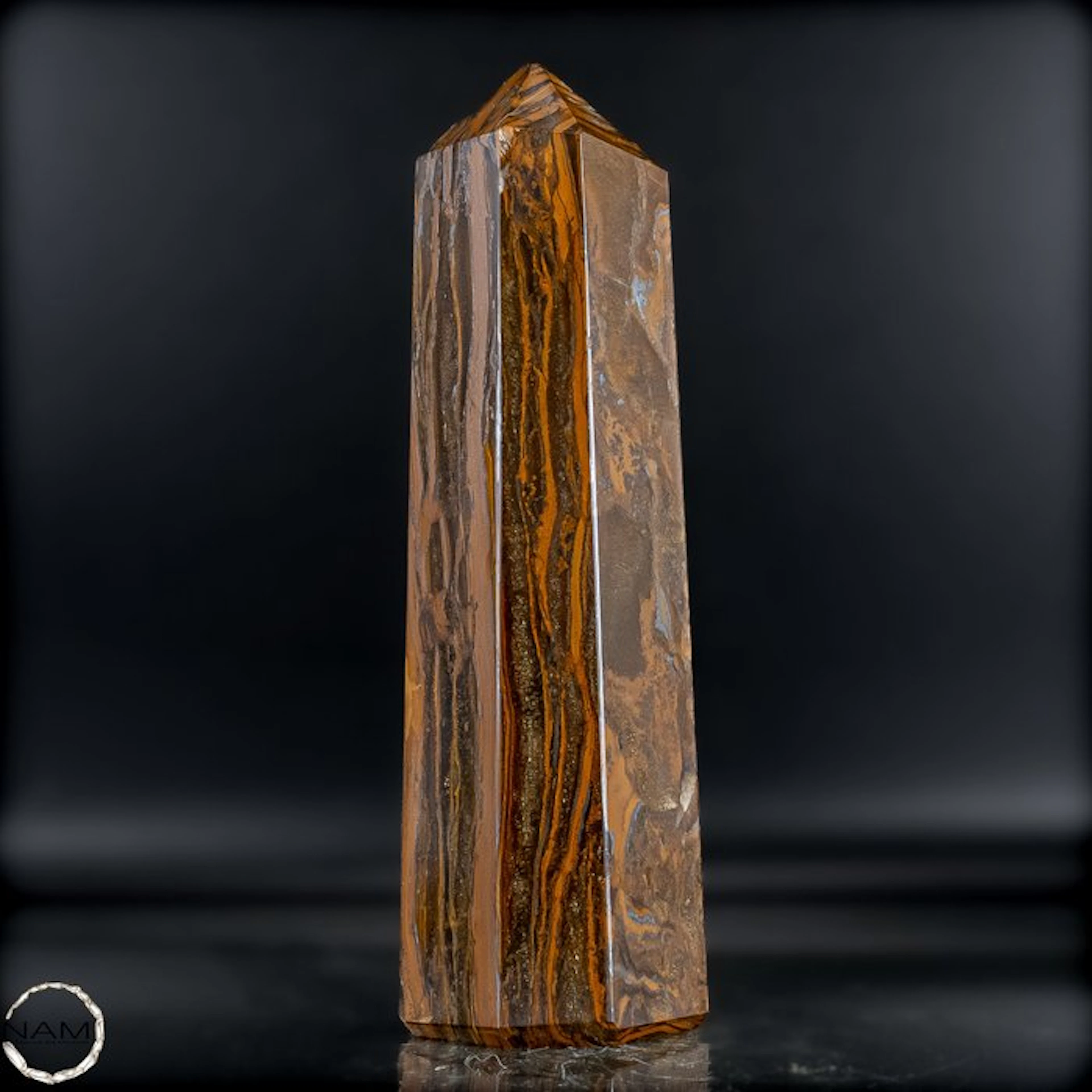 Natural tiger's-eye obelisk with a golden-brown silky texture.- 1141.36 g