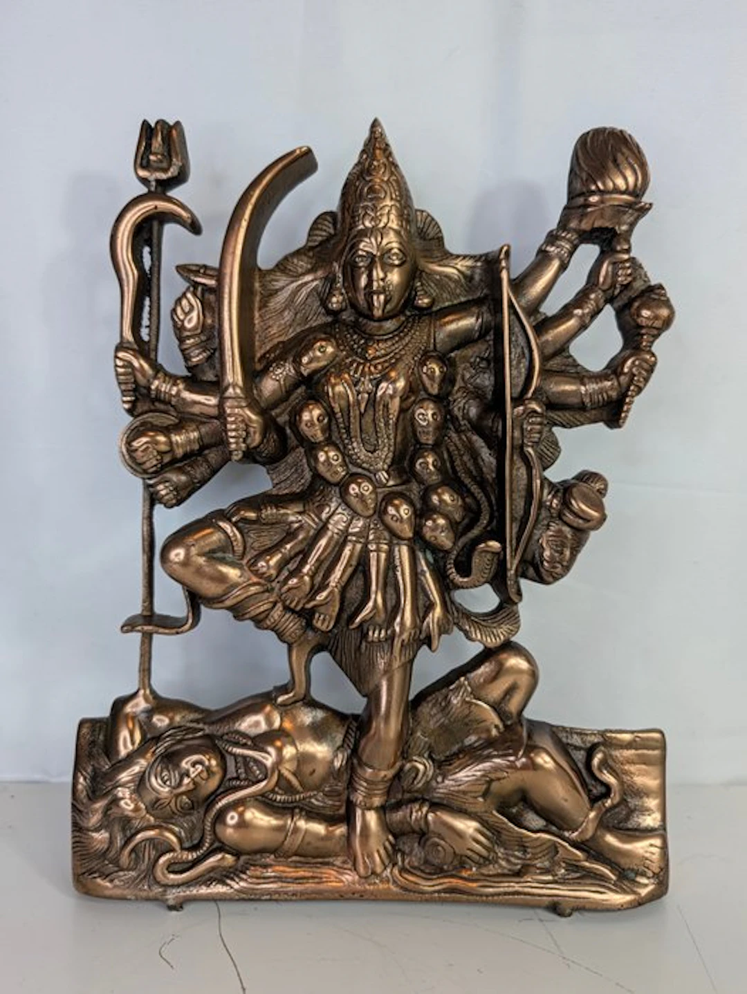 Brass figurine of the goddess Kali with many arms and a...