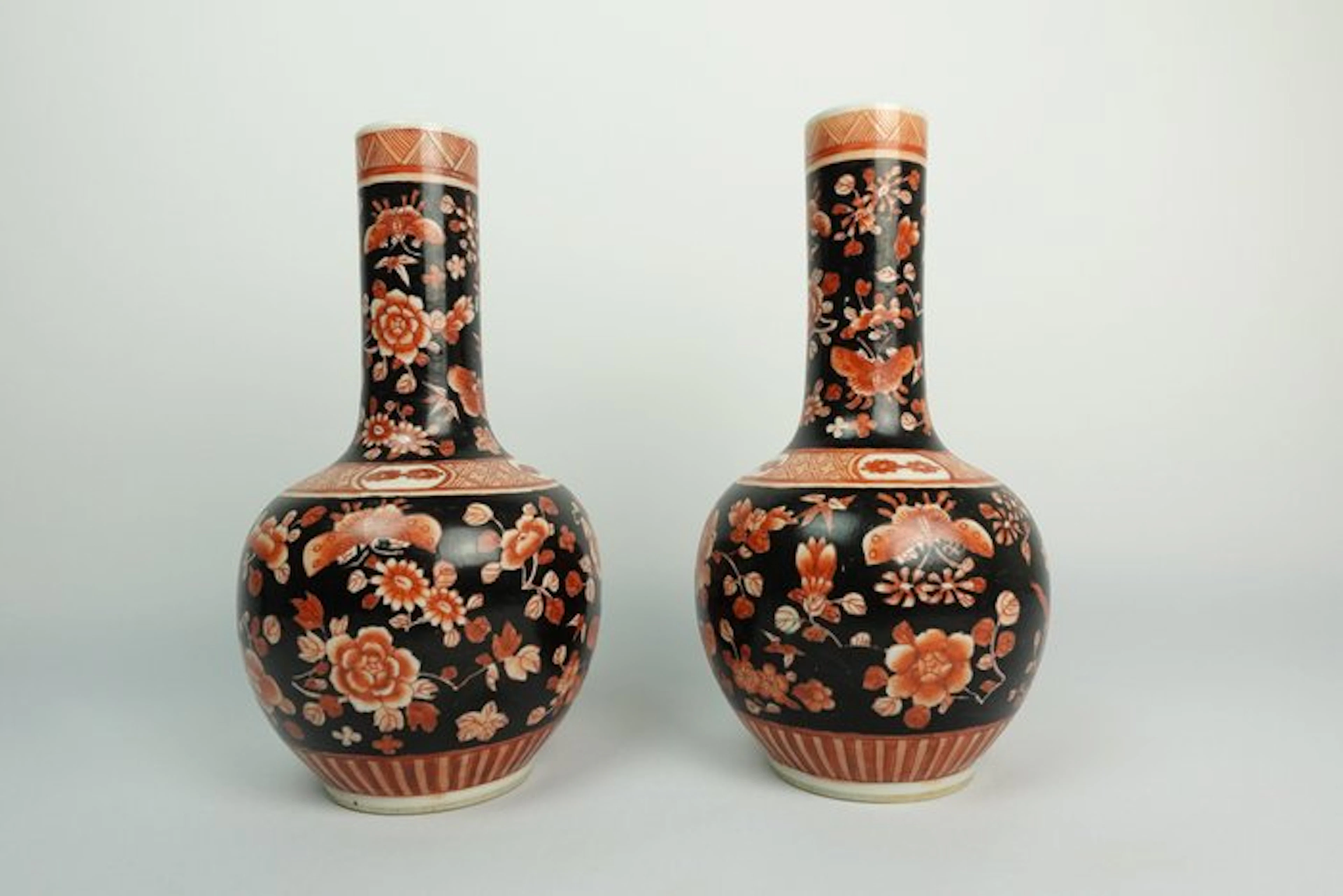 A pair of Chinese coral-red and ink-painted decorative vases