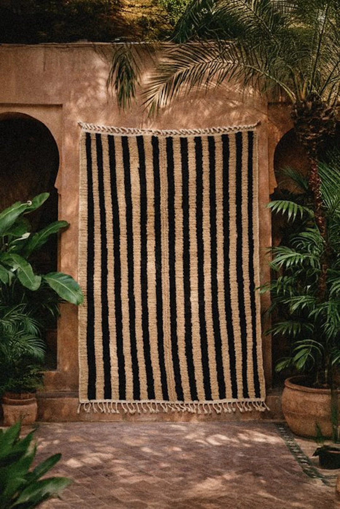 Handmade Amazigh Berber Beni Ourain rug with a striped pattern