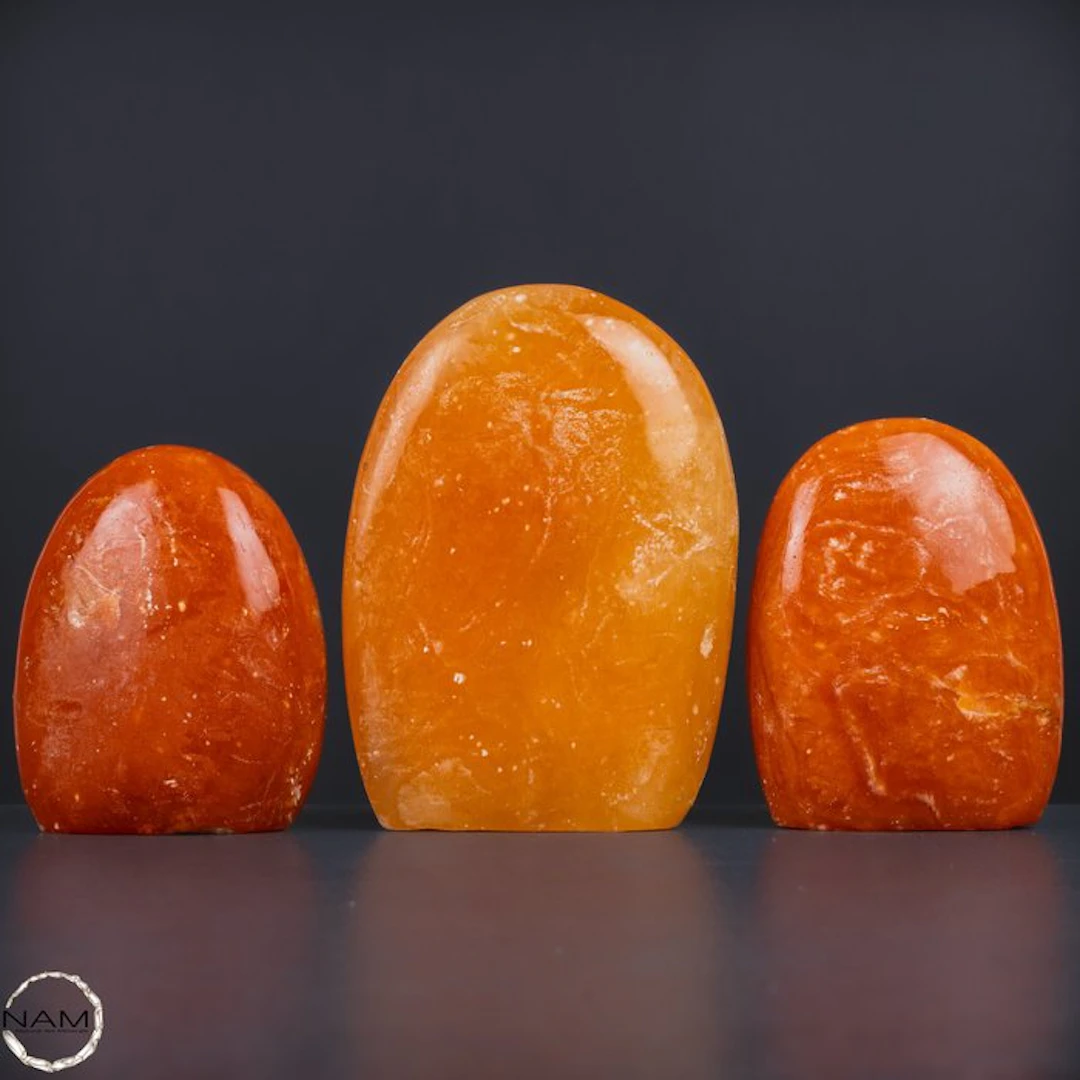 Radiant orange calcite freeform set – Three hand-polished...