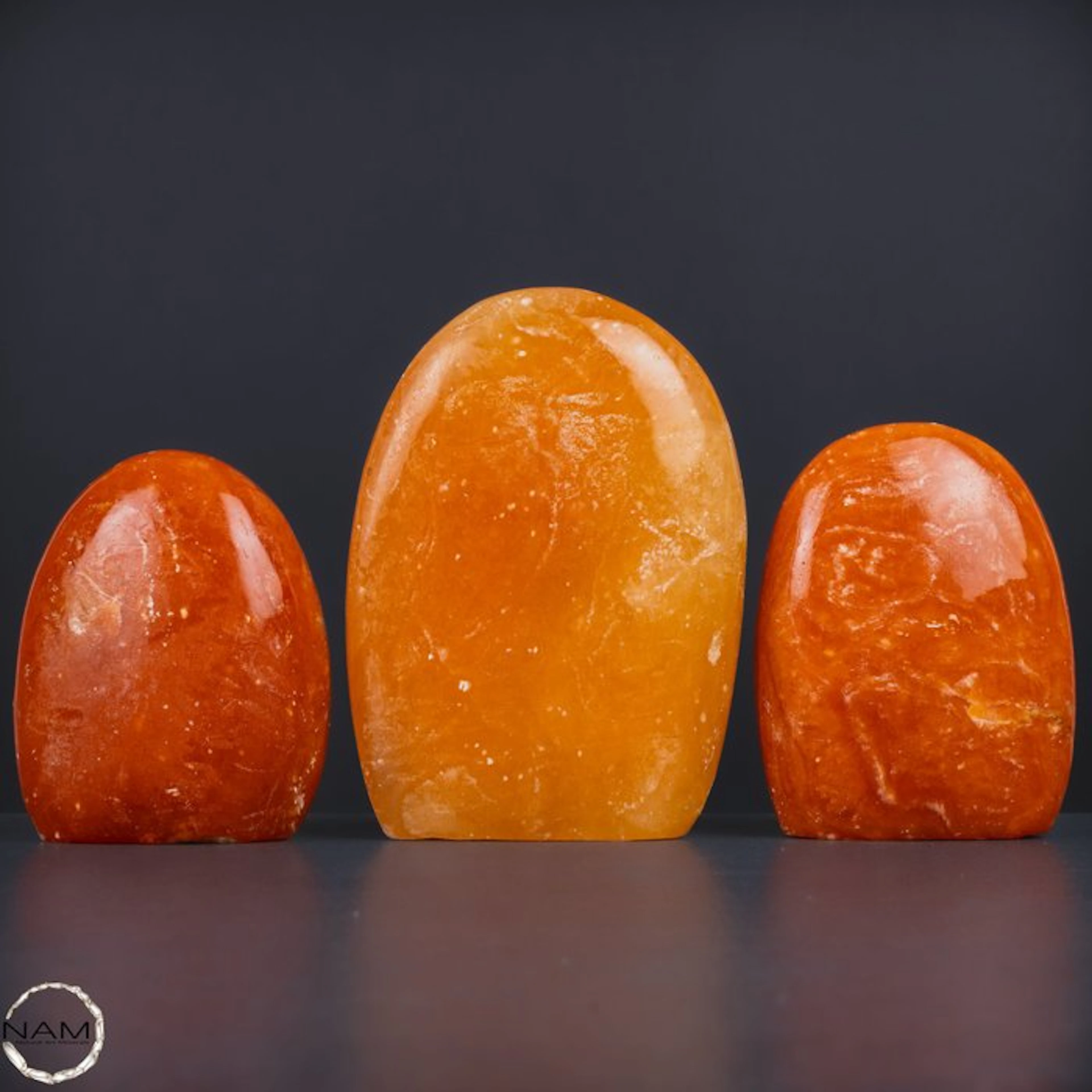 Radiant orange calcite freeform set – Three hand-polished...