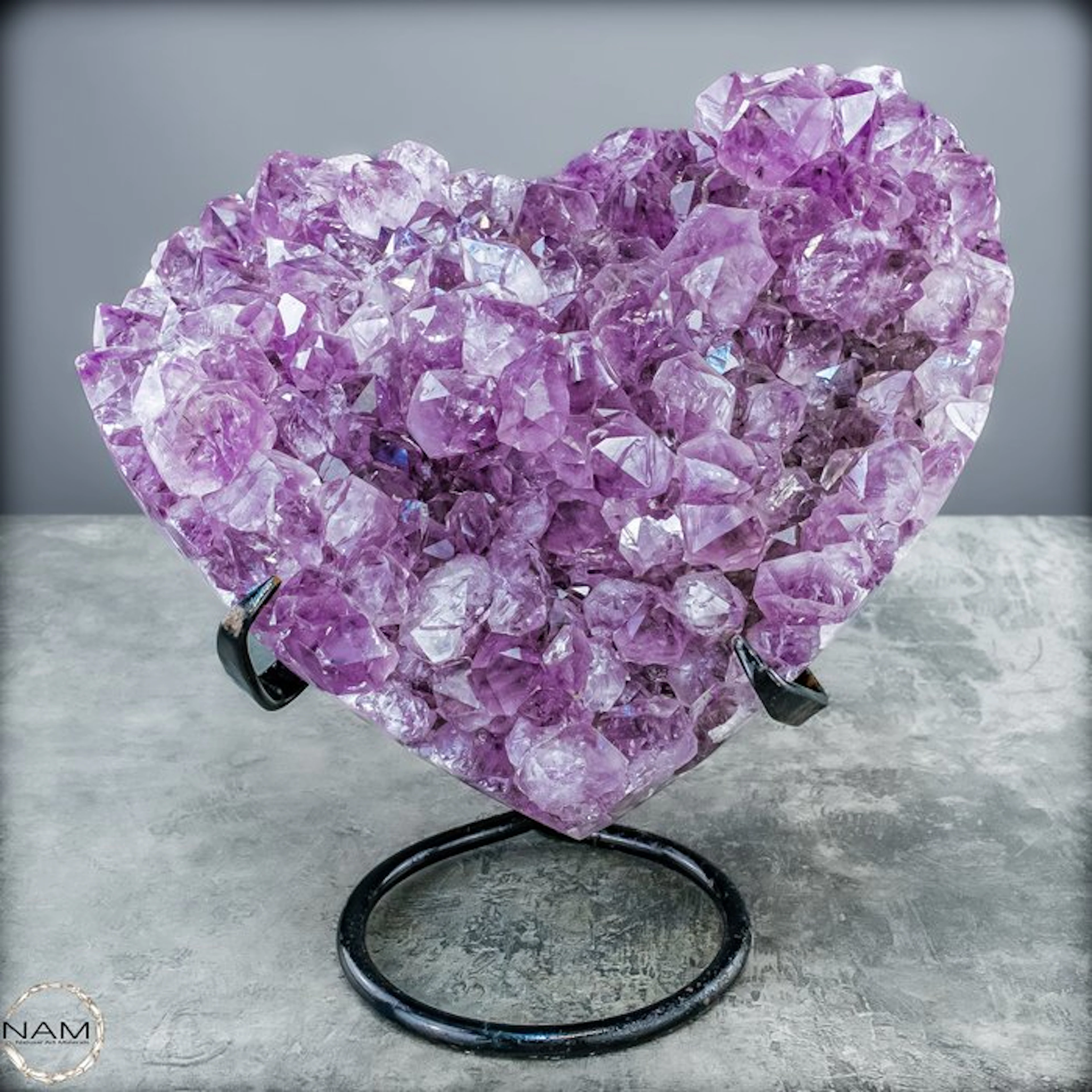 Radiant amethyst heart on a metal stand – An eye-catching...