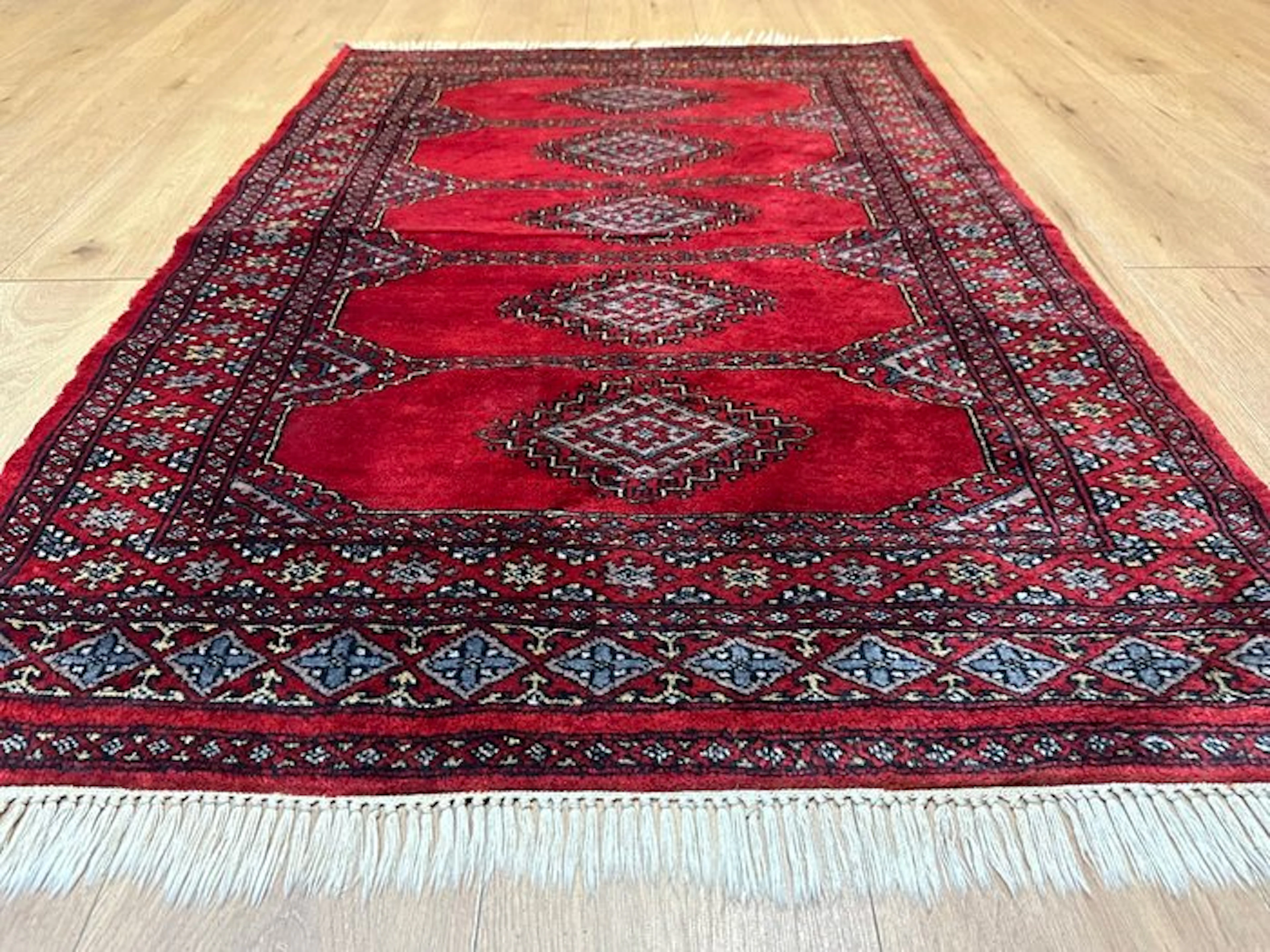 Hand-knotted Pakistan Bokhara Oriental rug with a classic...