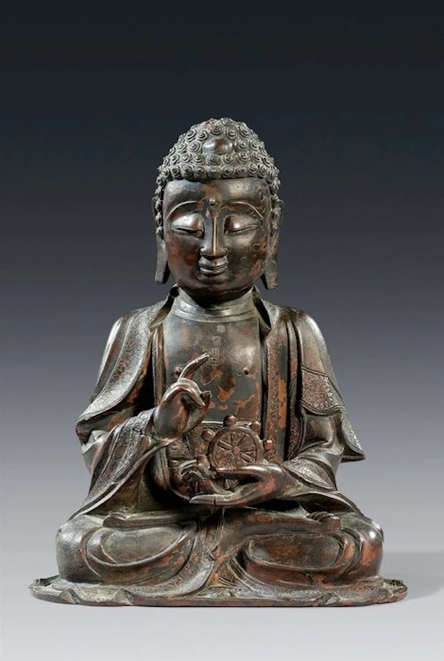 A Large Bronze Figure of a Buddha Holding the Wheel of...