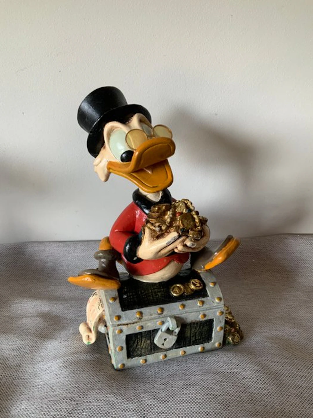 Disney - Uncle Scrooge sitting on a Treasure Box 28 cm