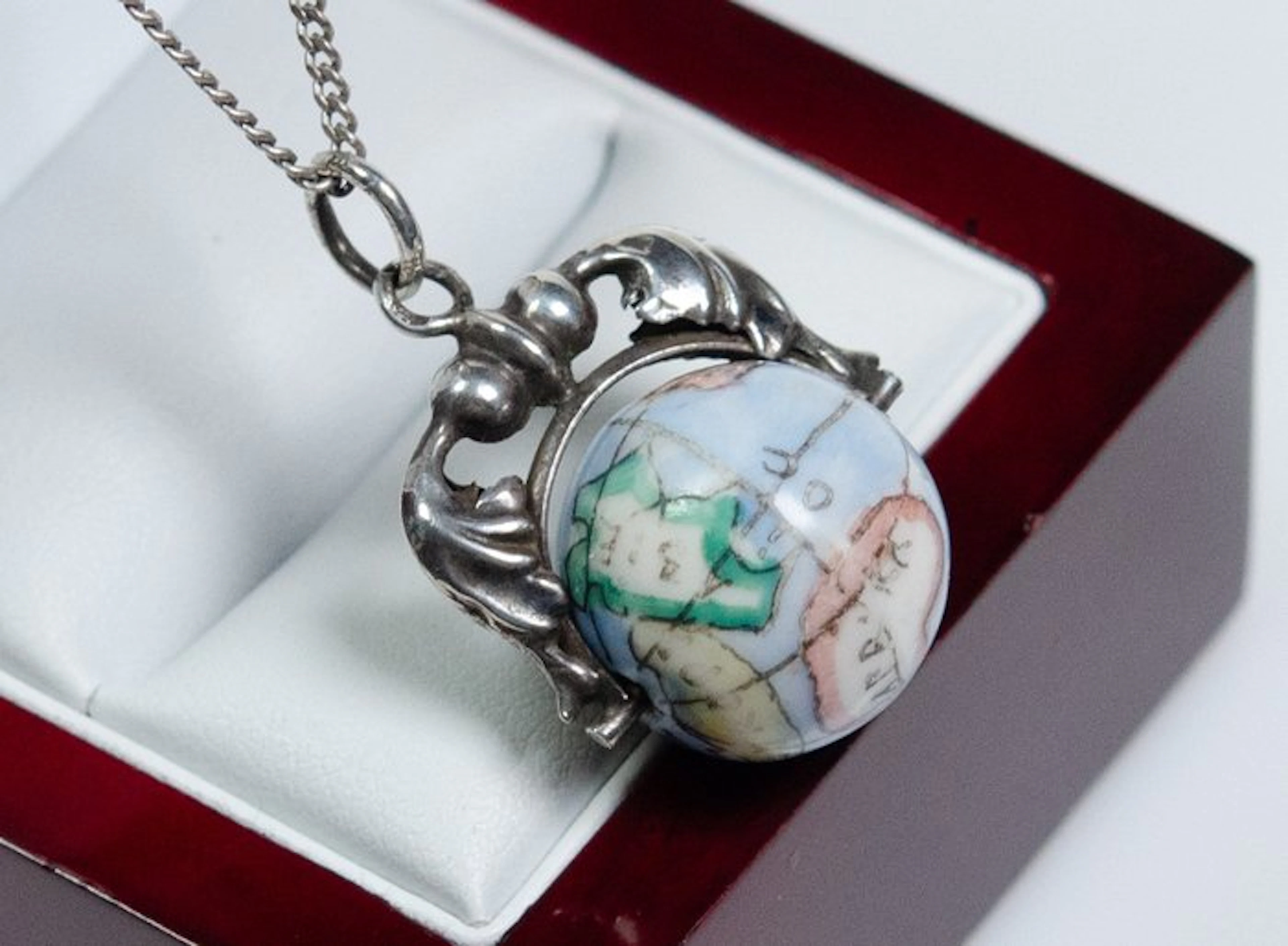 min. 800 silver - globe-shaped - hand-painted - rotatable...