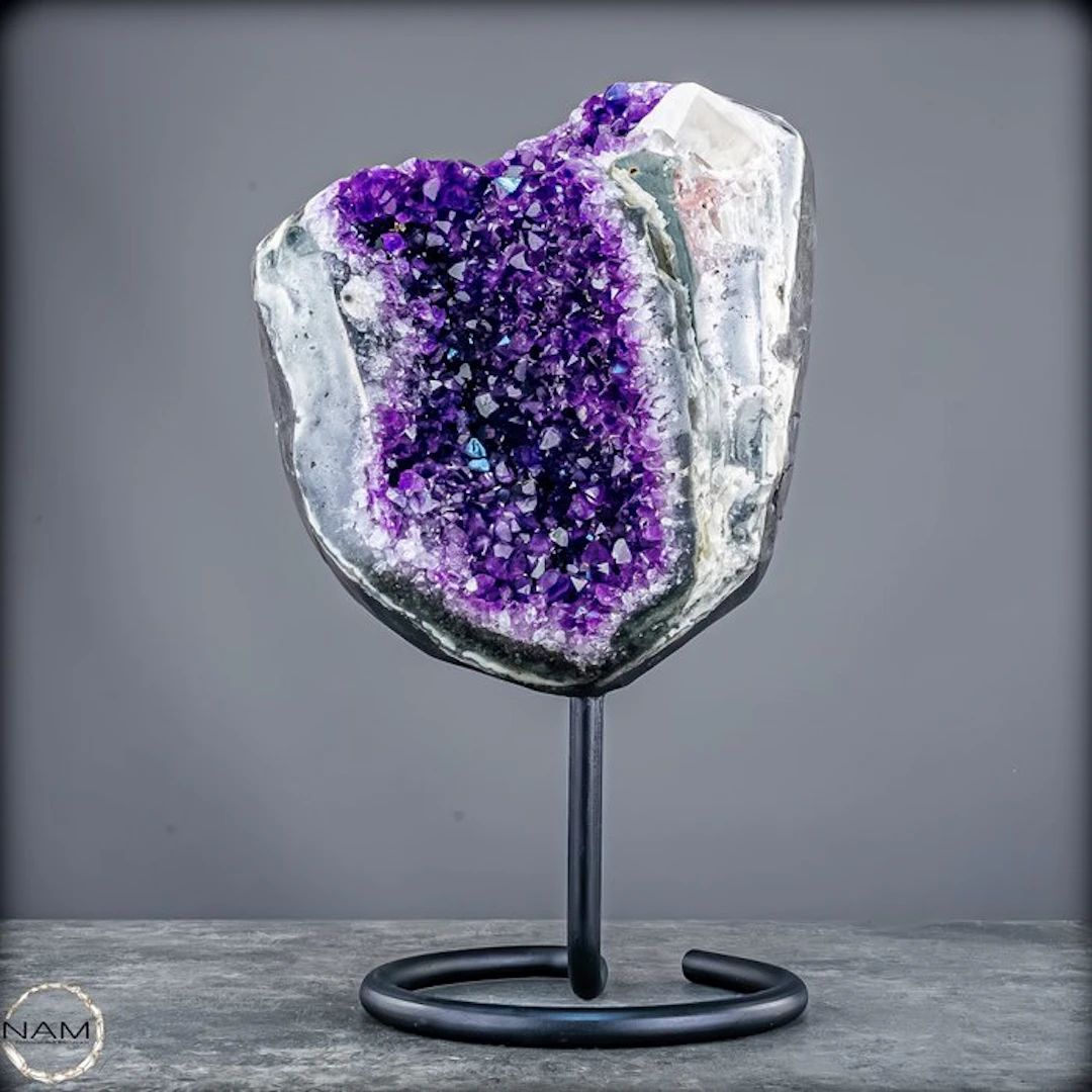 Amethyst druse on a stand with a large calcite crystal –...