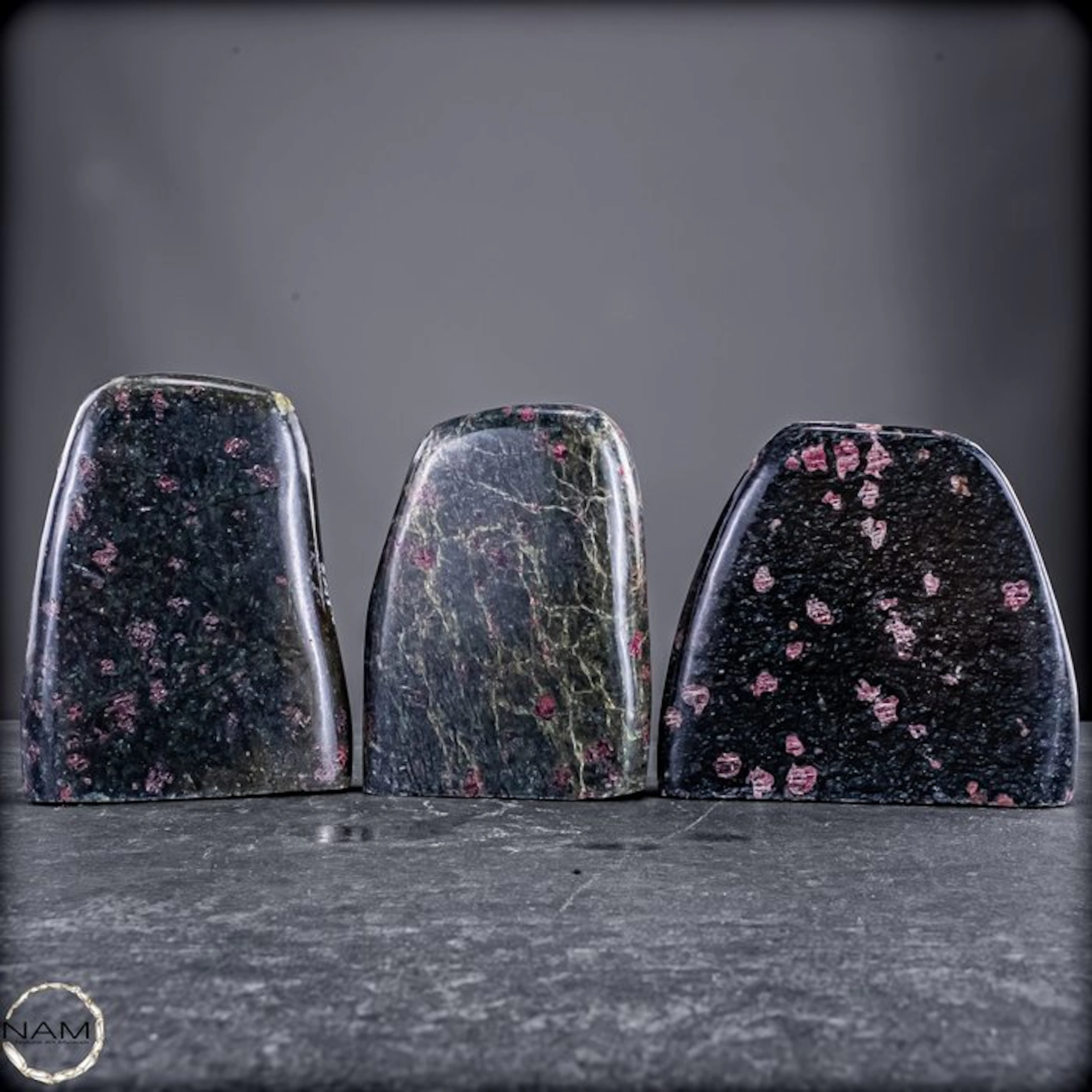 Extraordinary 3-piece almandine garnet set in green...