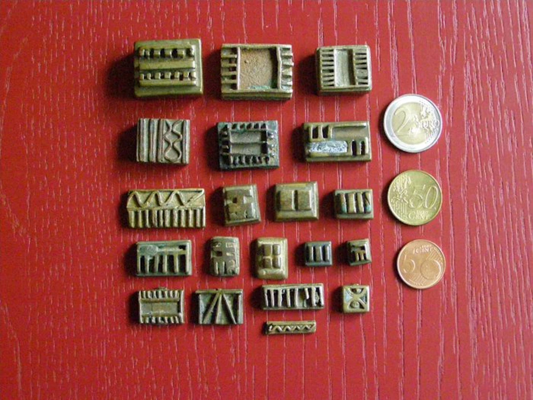 Twenty antique geometric gold weights