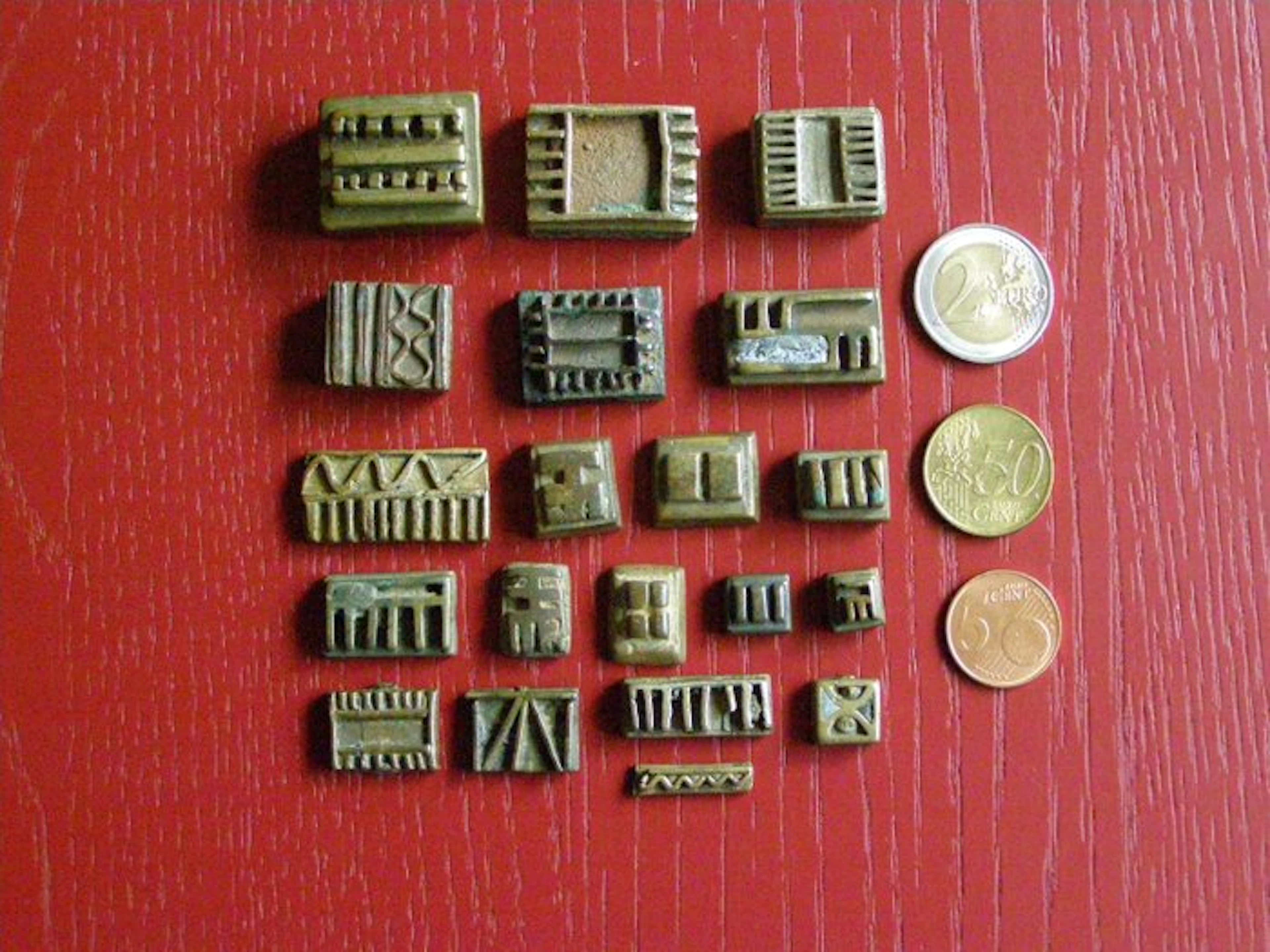 Twenty antique geometric gold weights