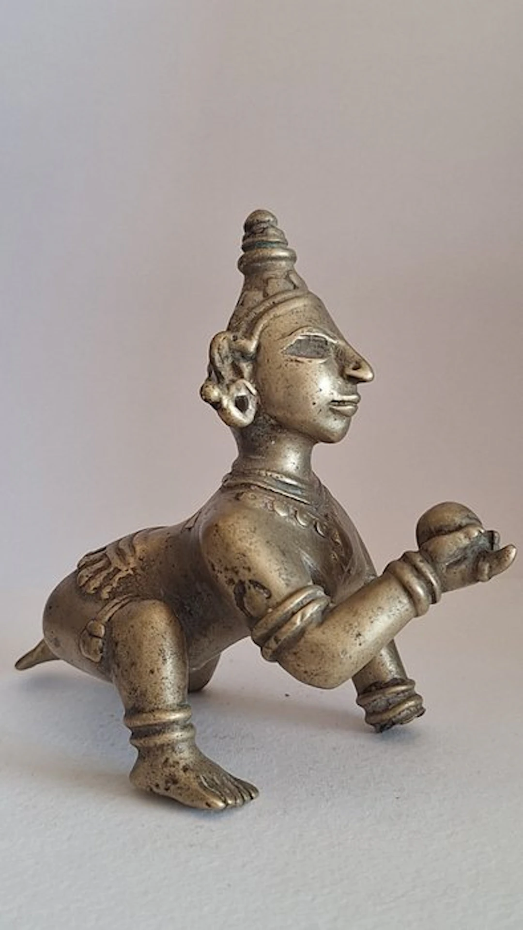 Antique brass statuette hand-sculpted depicting the baby...