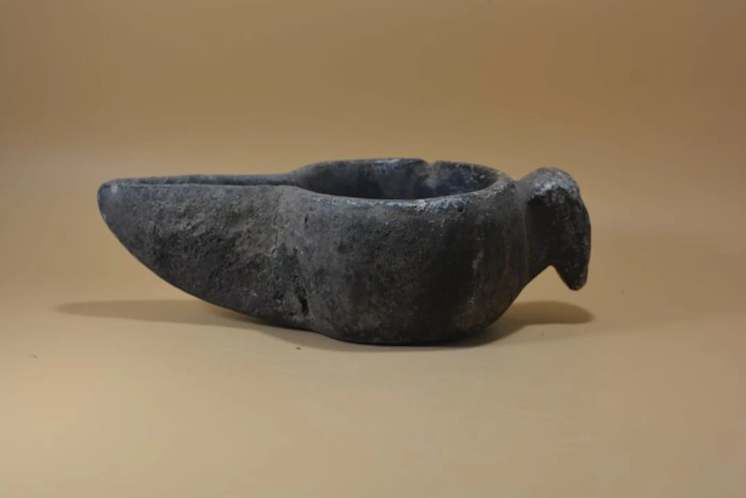 Medieval Islamic carved steatite oil lamp with elongated...