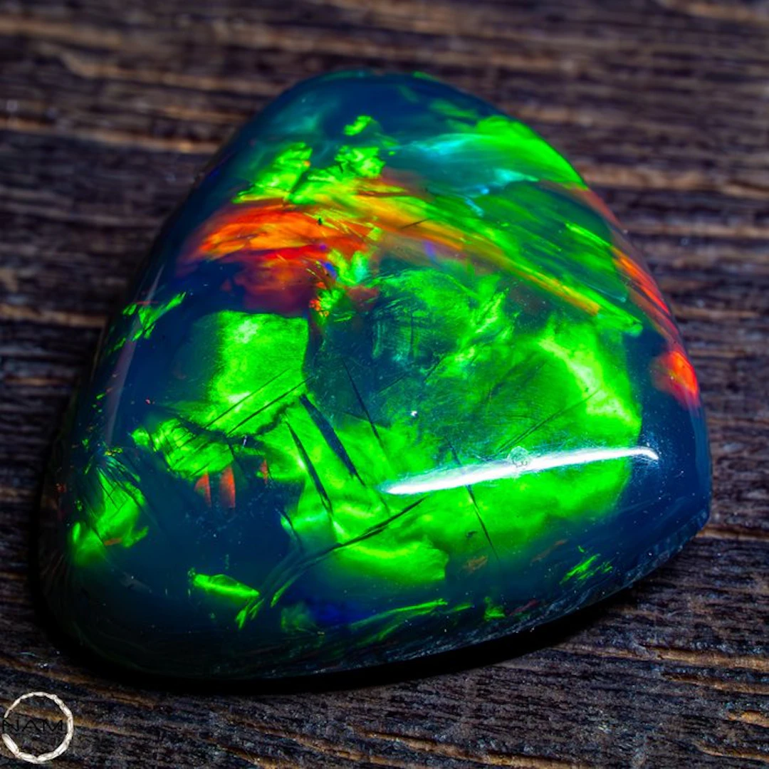Black opal cabochon with an intense green-gold play of color. 17.45 ct- 3.49 g