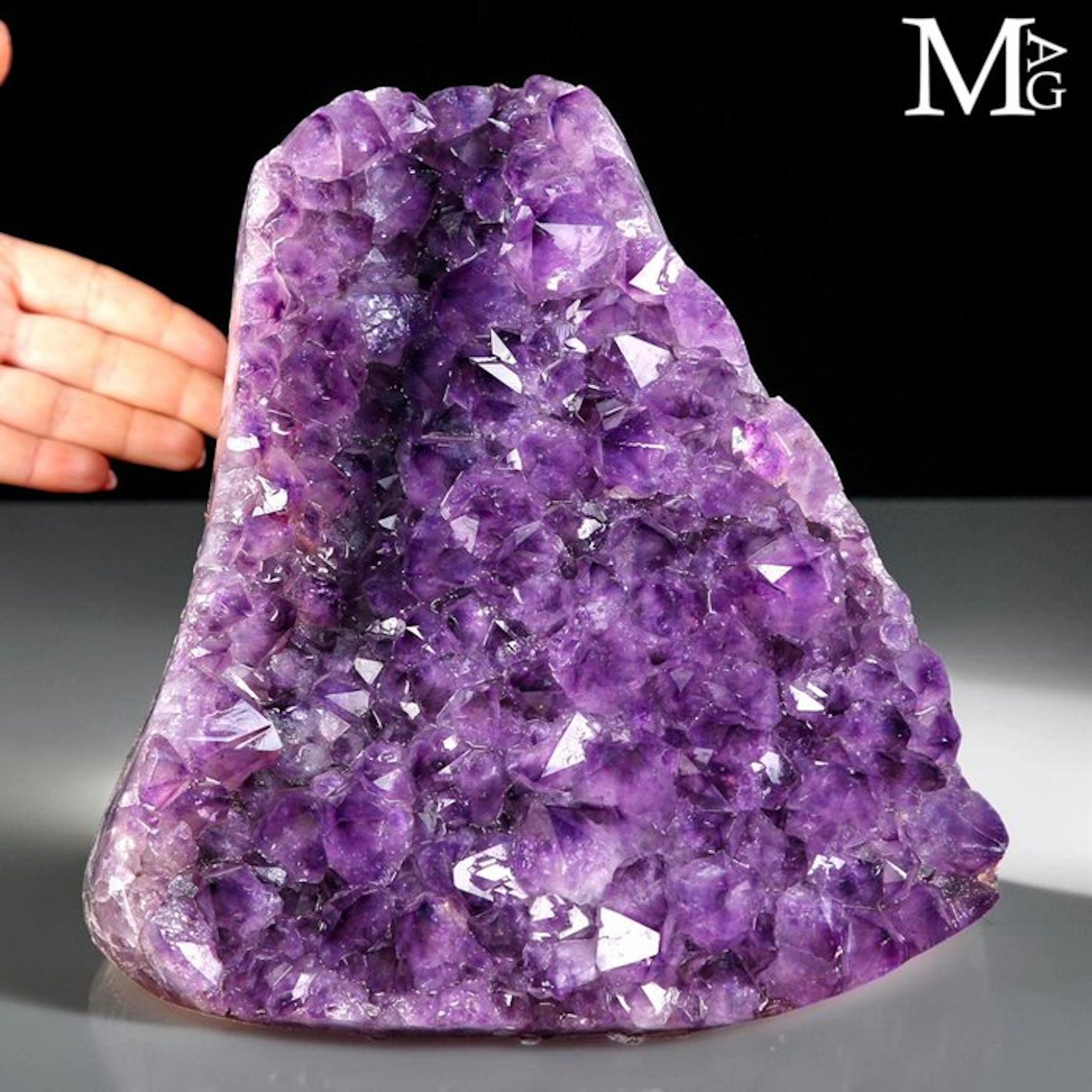 Cluster of natural deep purple amethyst crystals...