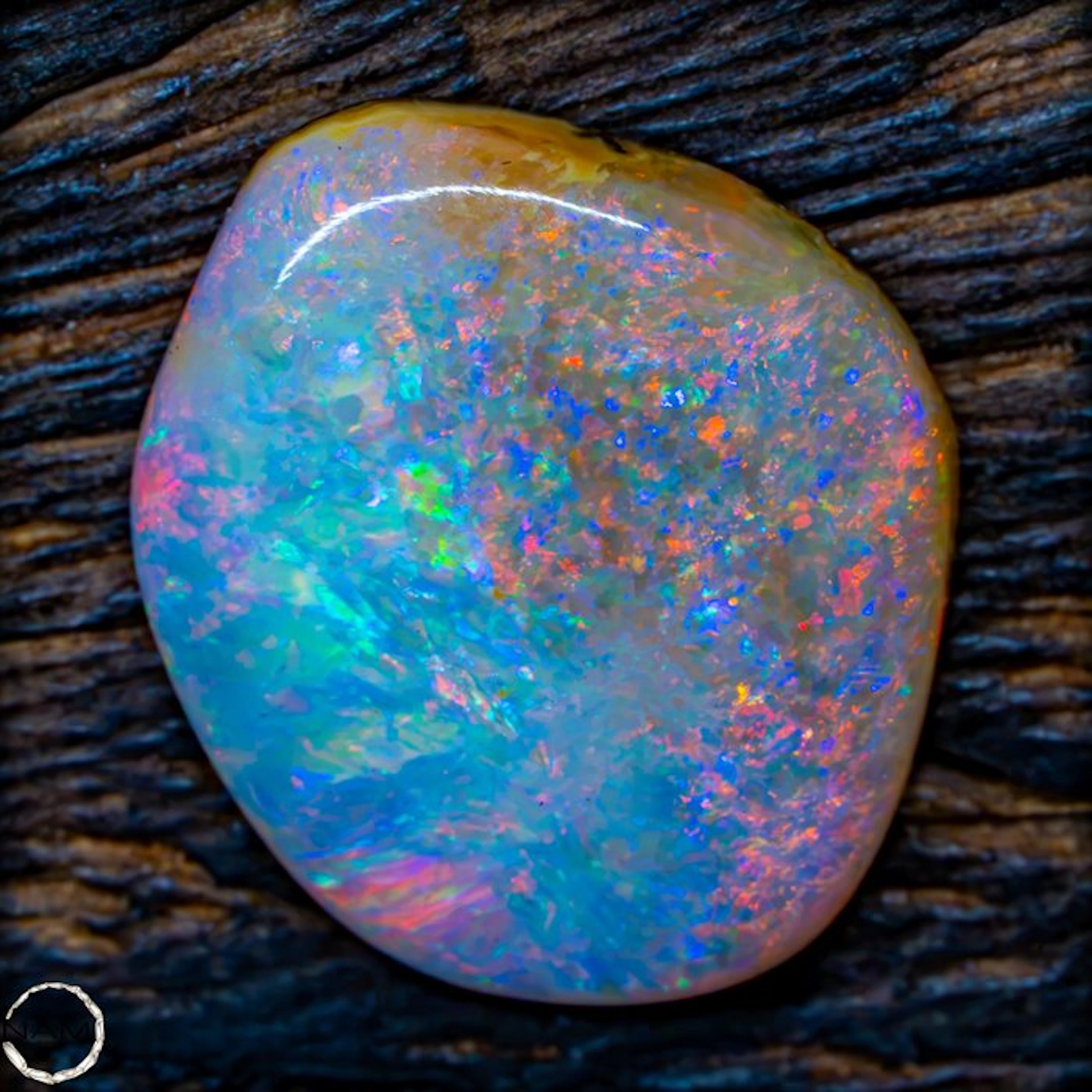 Natural semi-black opal – a brilliant display of color in...