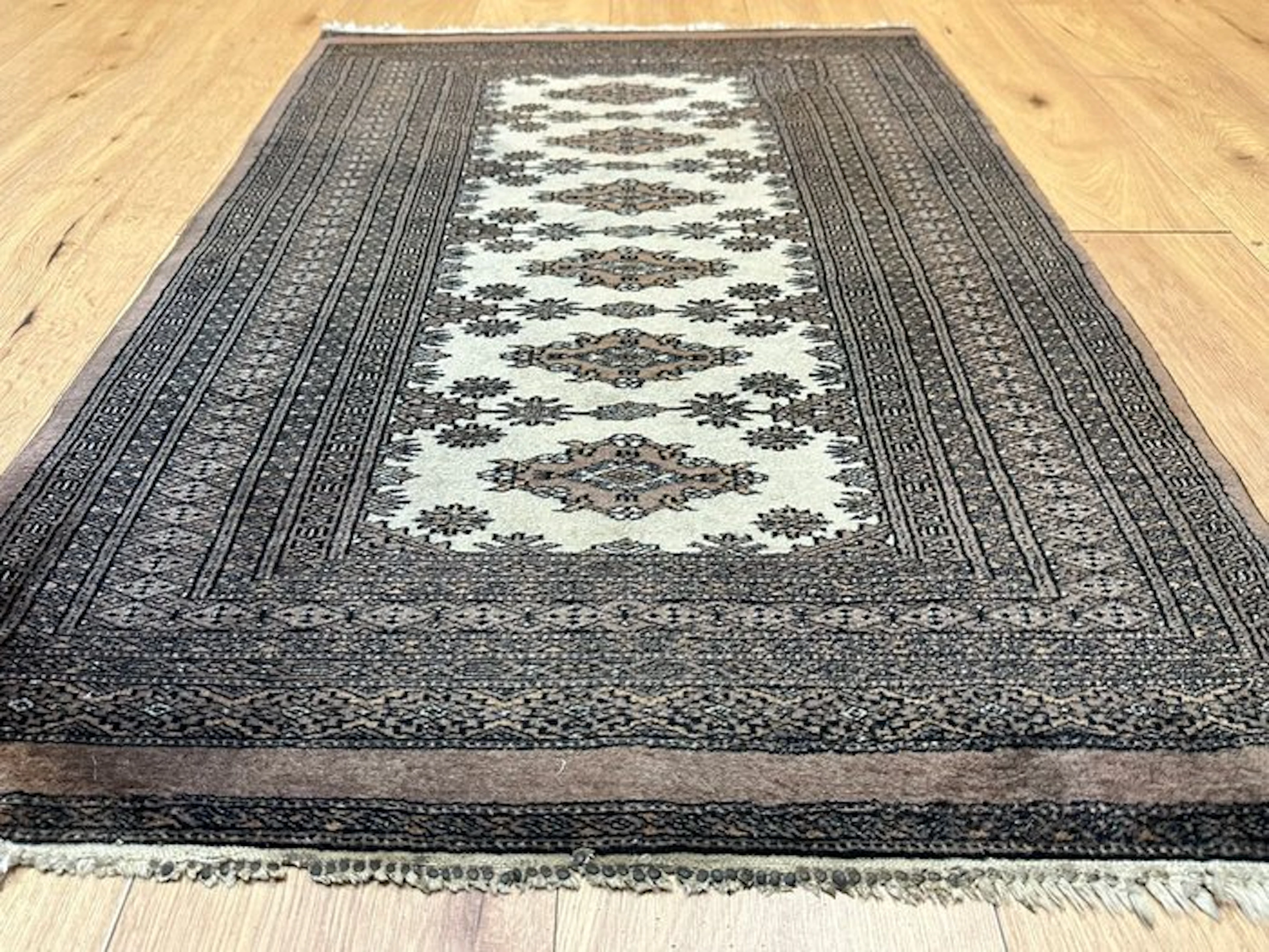 Hand-knotted Pakistan Bokhara Oriental rug with a classic...