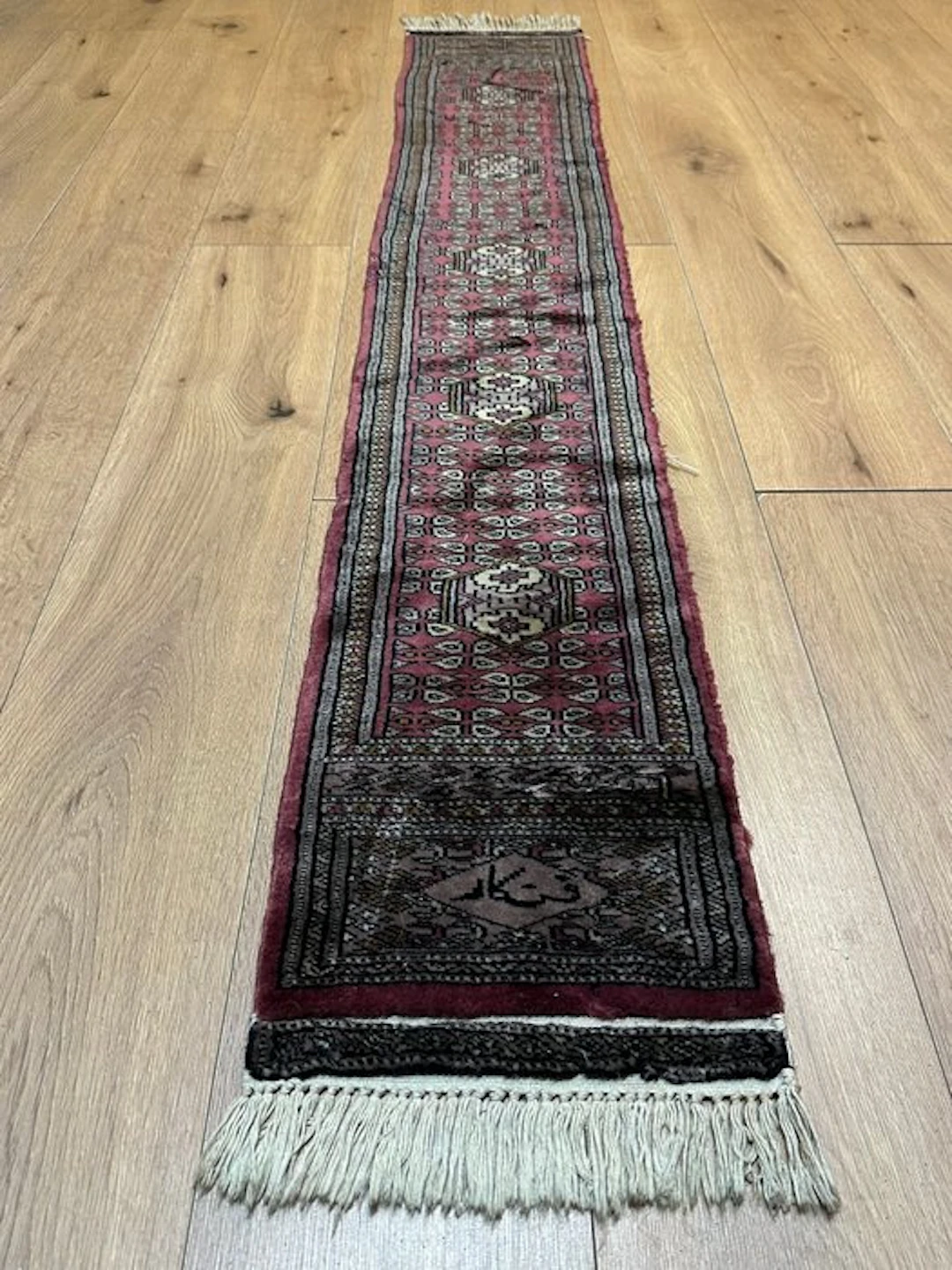 Signed Bukhara runner — hand-knotted Oriental rug with a...