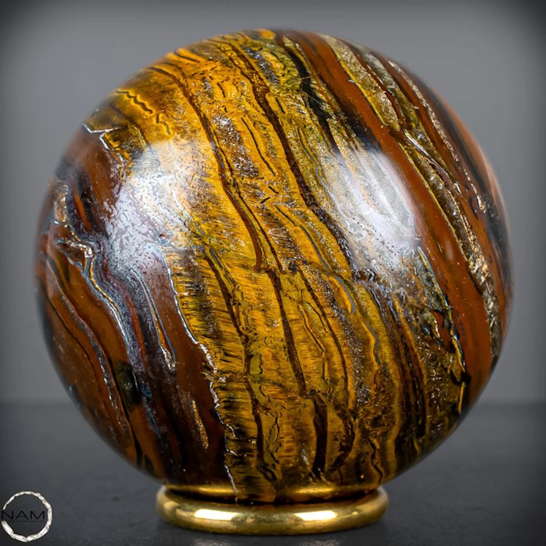 Natural tiger's eye sphere – intense gold veins with a lively shimmer- 876.99 g