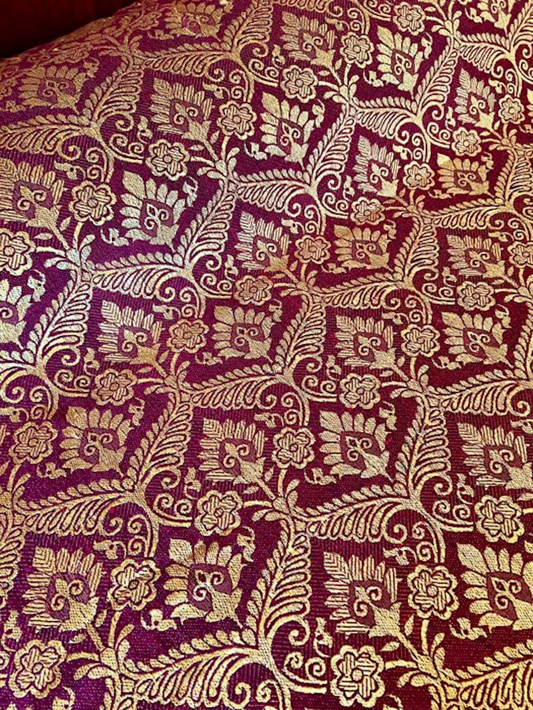 Antique gold-plaid quilt on burgundy