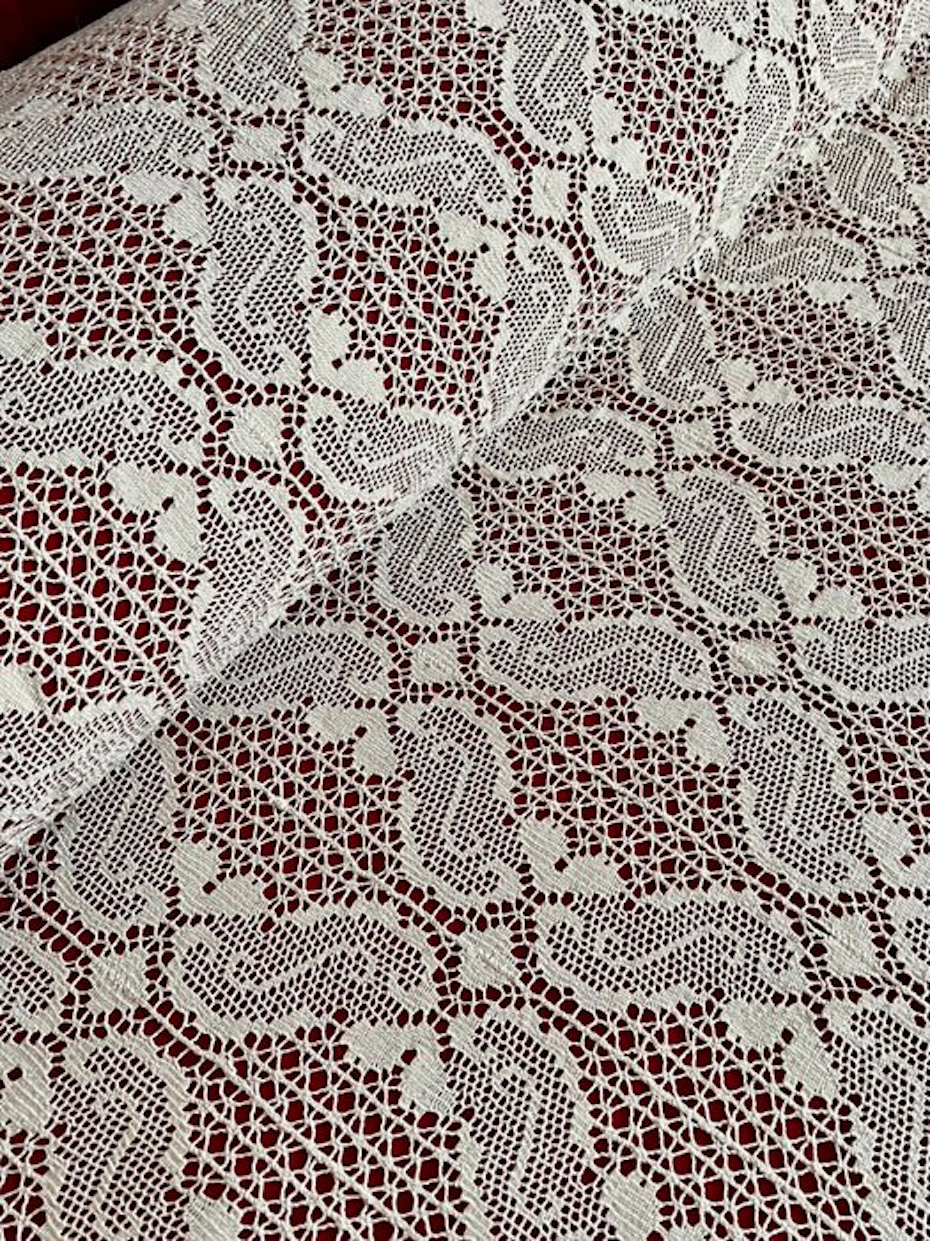 ** Antique cream-colored bobbin lace bedspread for double beds
