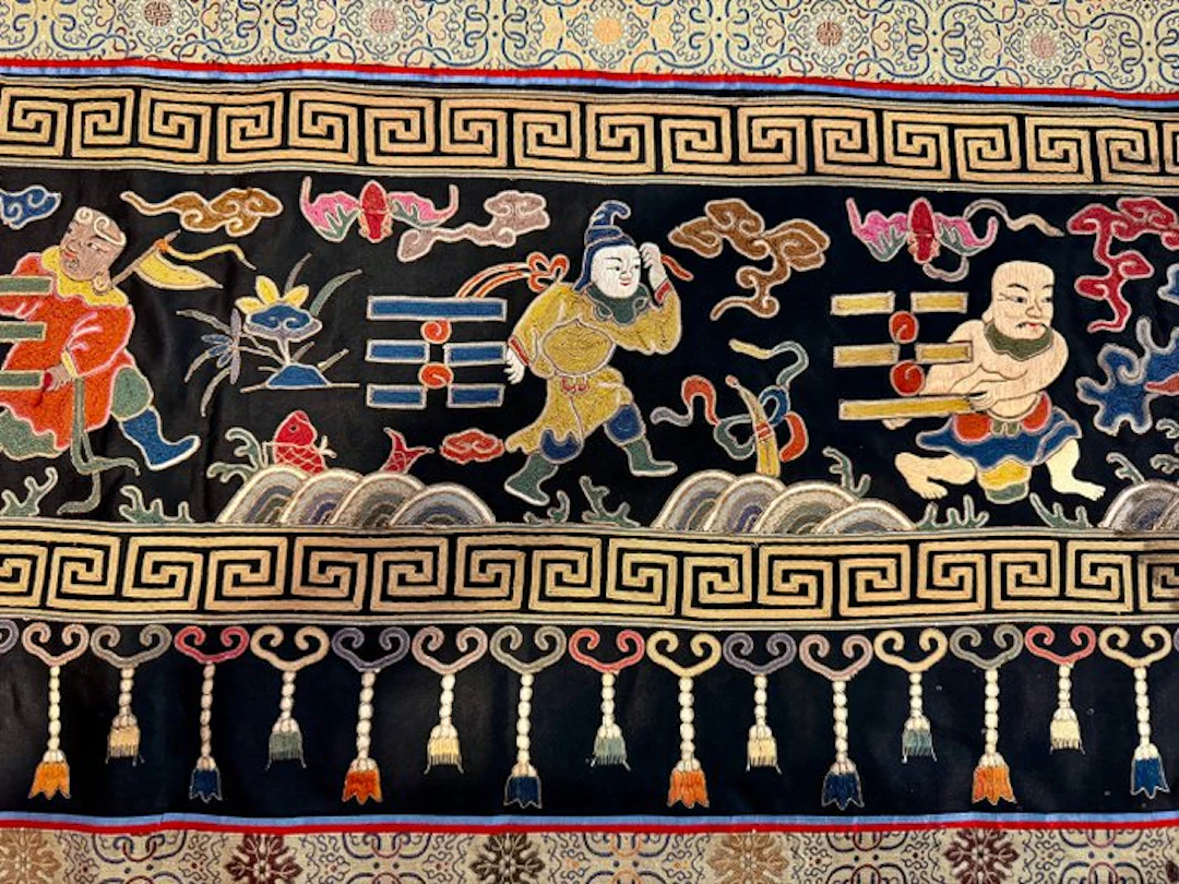 An Embroidered Silk Hanging Panel Depicting Eight Figures