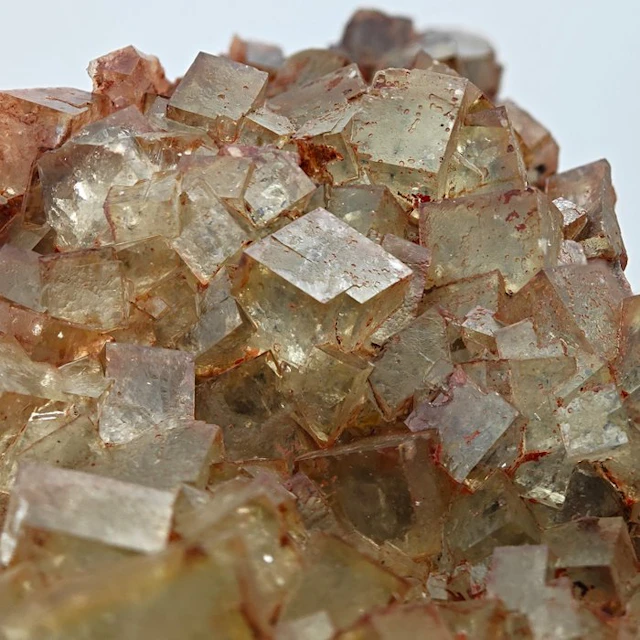 100+ green fluorites with red hematite