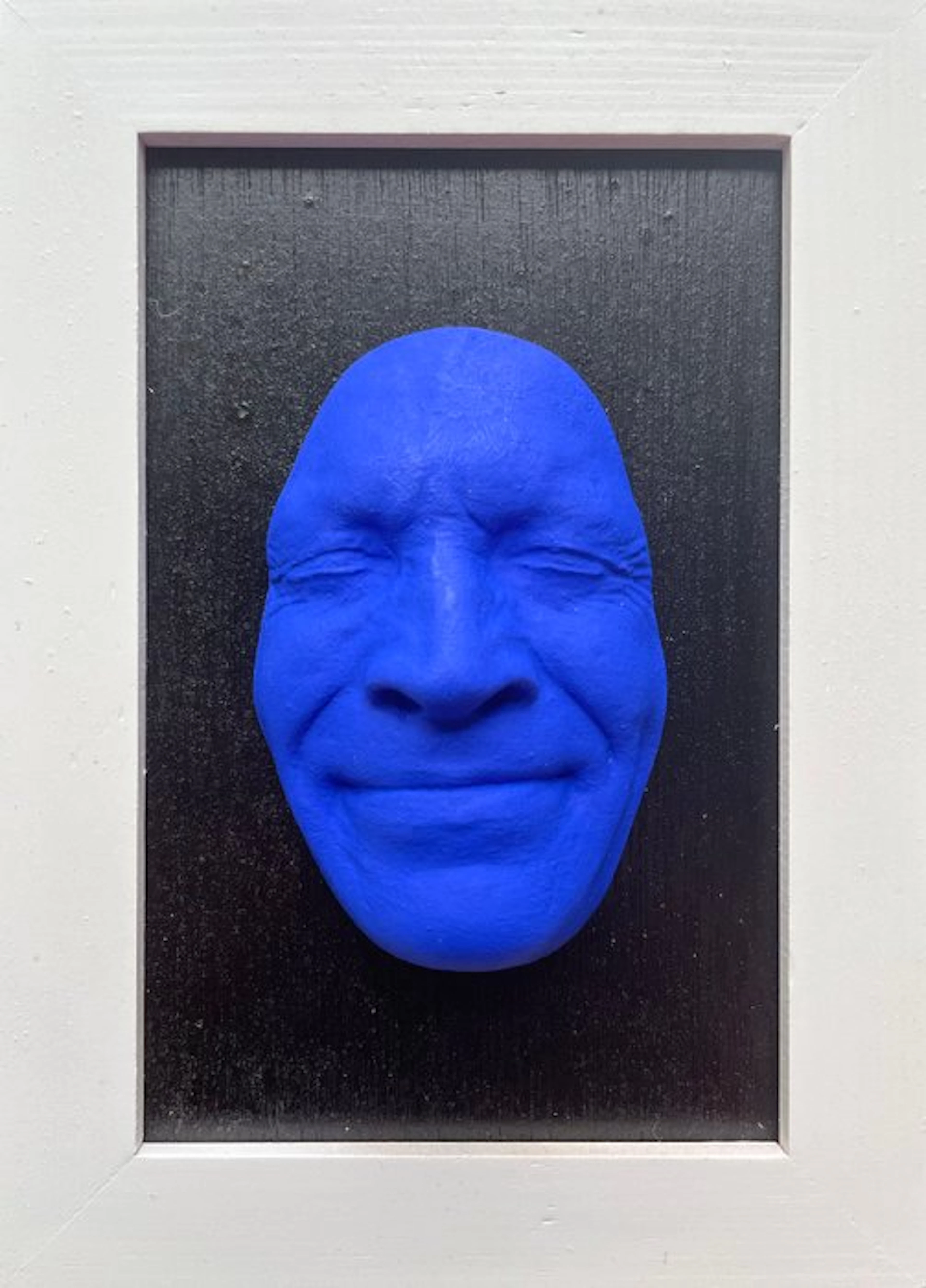 gregos - Blue smile on black background-white frame