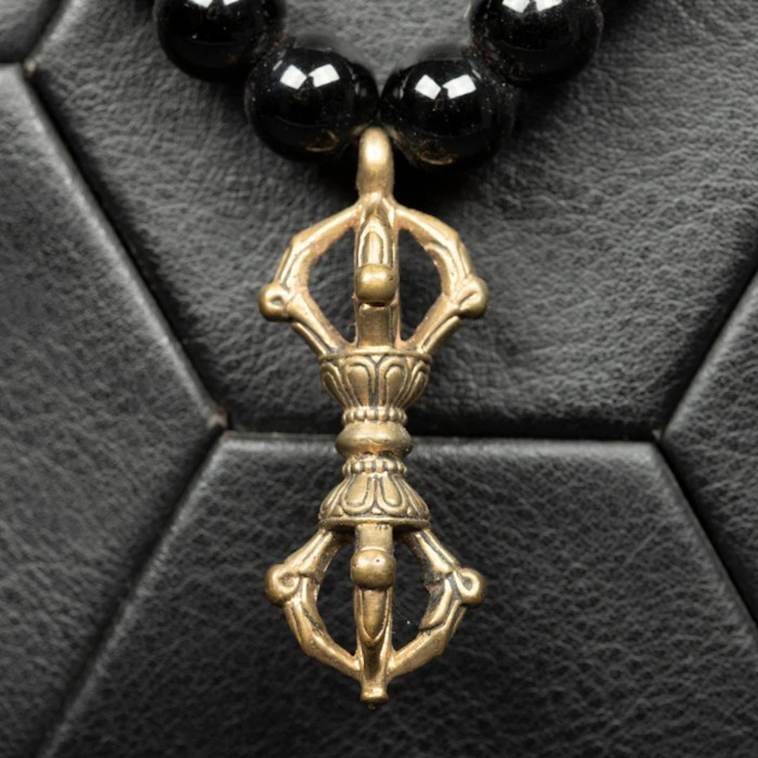 Deep Black Onyx Beads with an Intricate Tibetan Dorje...
