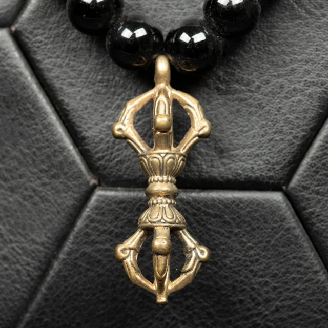 Deep Black Onyx Beads with an Intricate Tibetan Dorje...