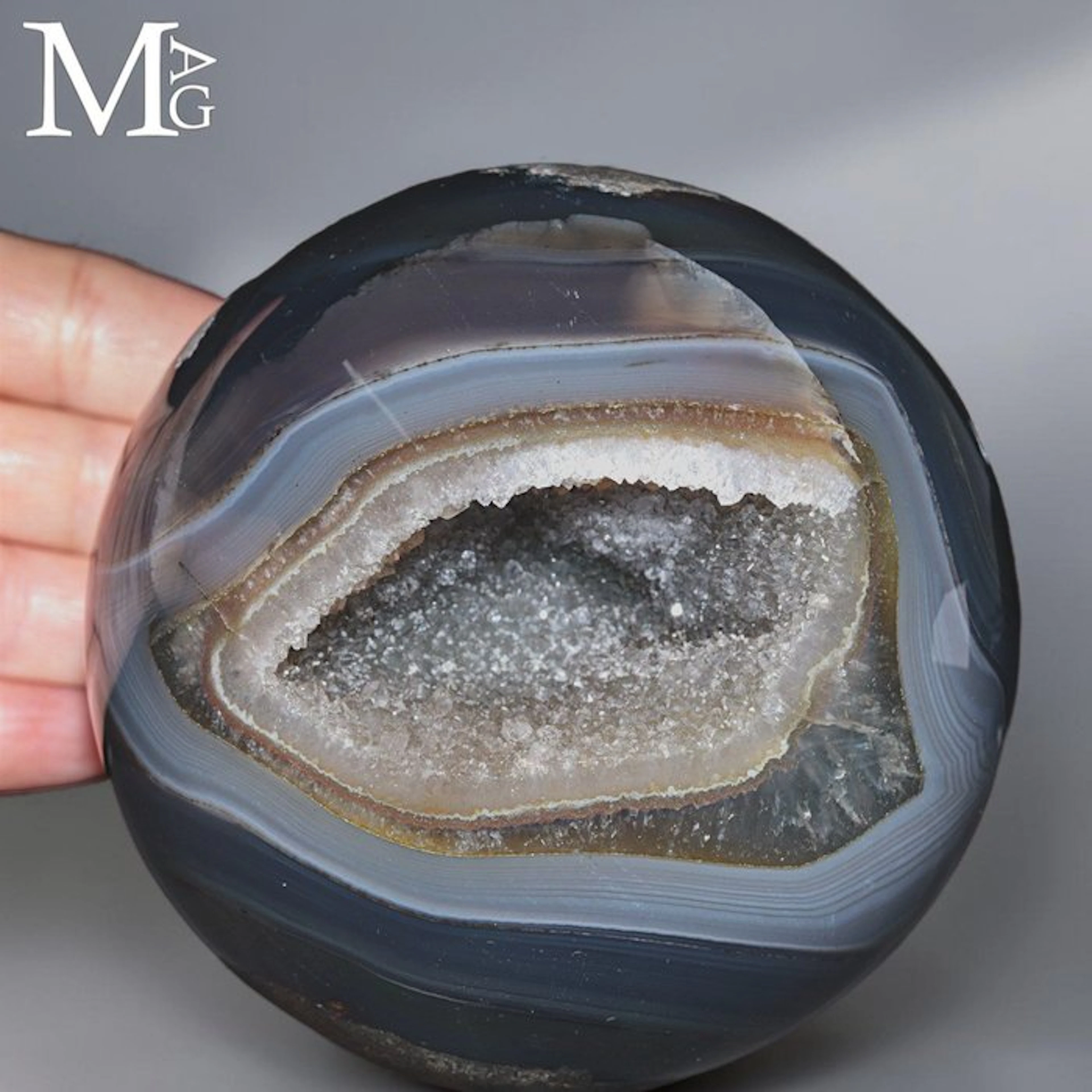 Polished Agate Sphere revealing a sparkling Quartz geode...