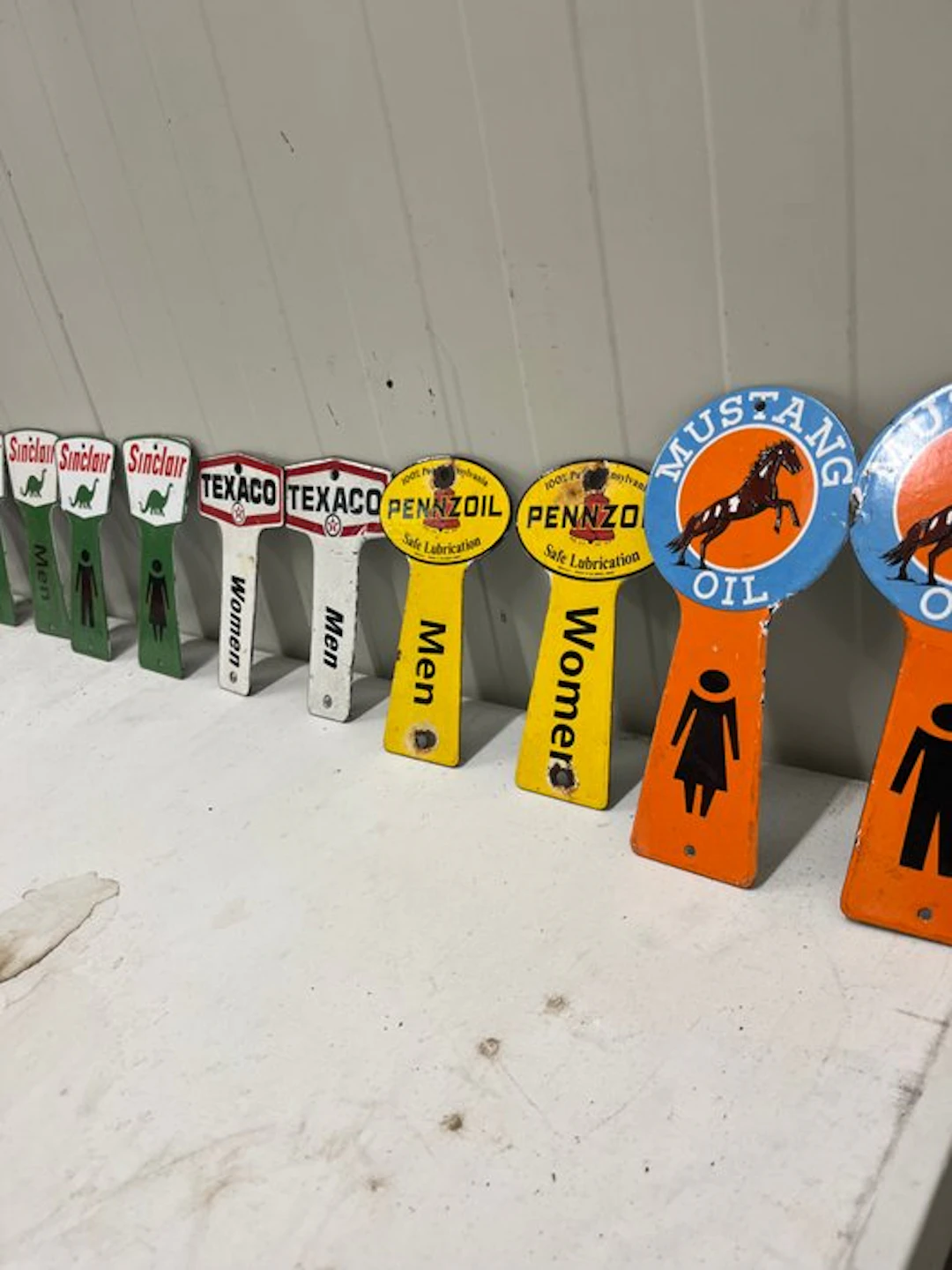 Large collection of gas-pump toilet signs – Sinclair