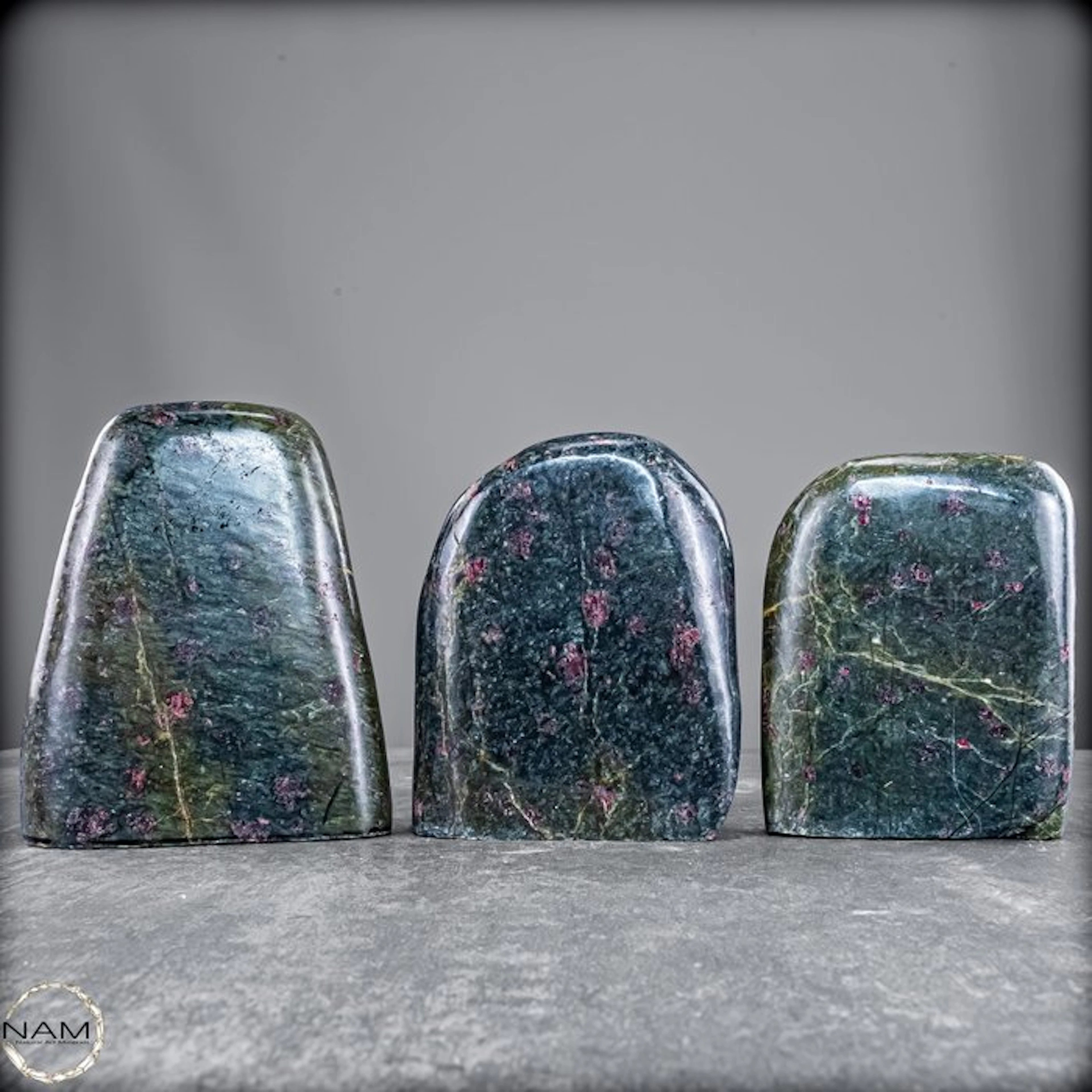 Extraordinary 3-piece almandine garnet set in green...