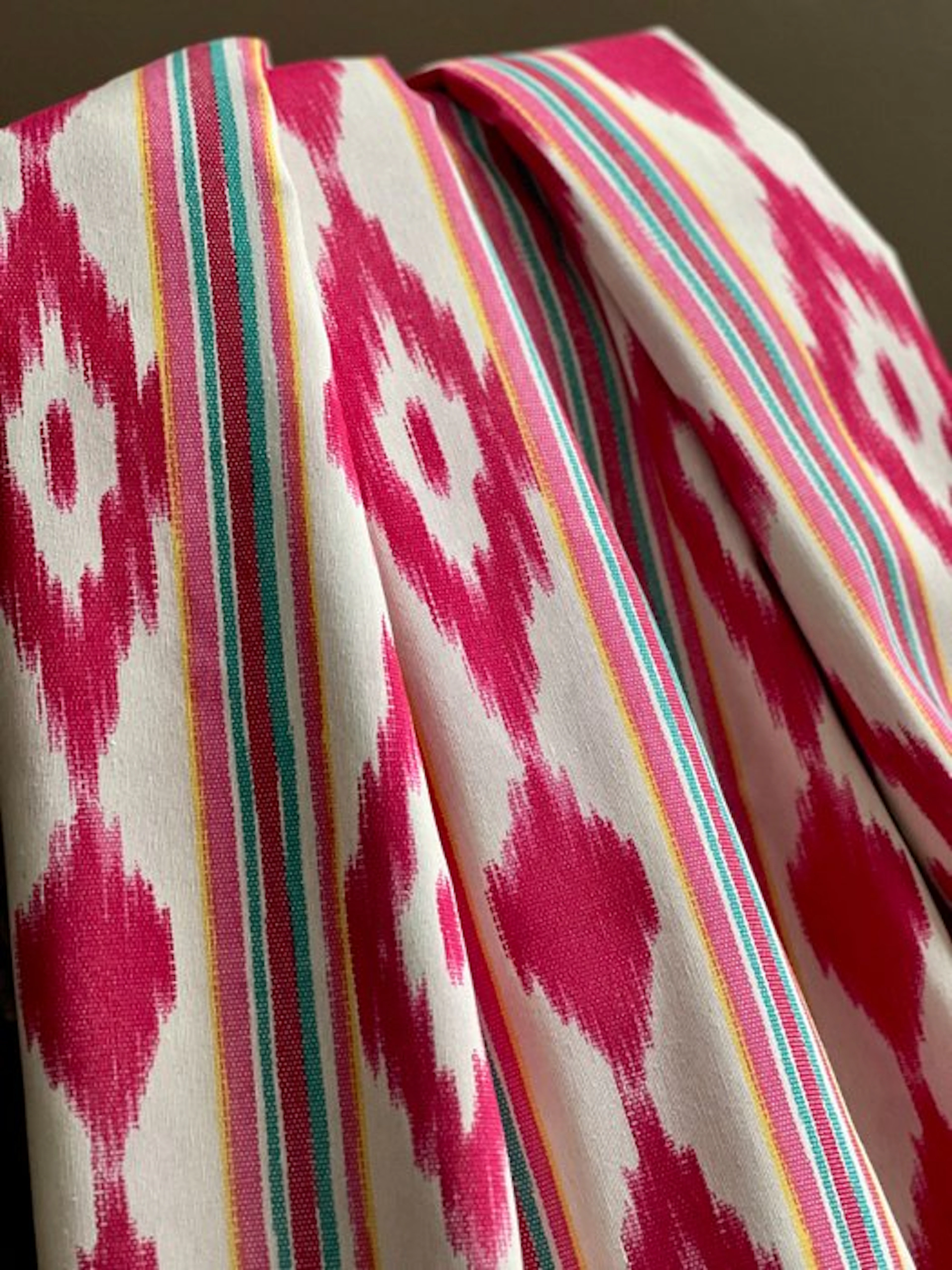 Double-width fabric with a multicolor fuchsia ikat print