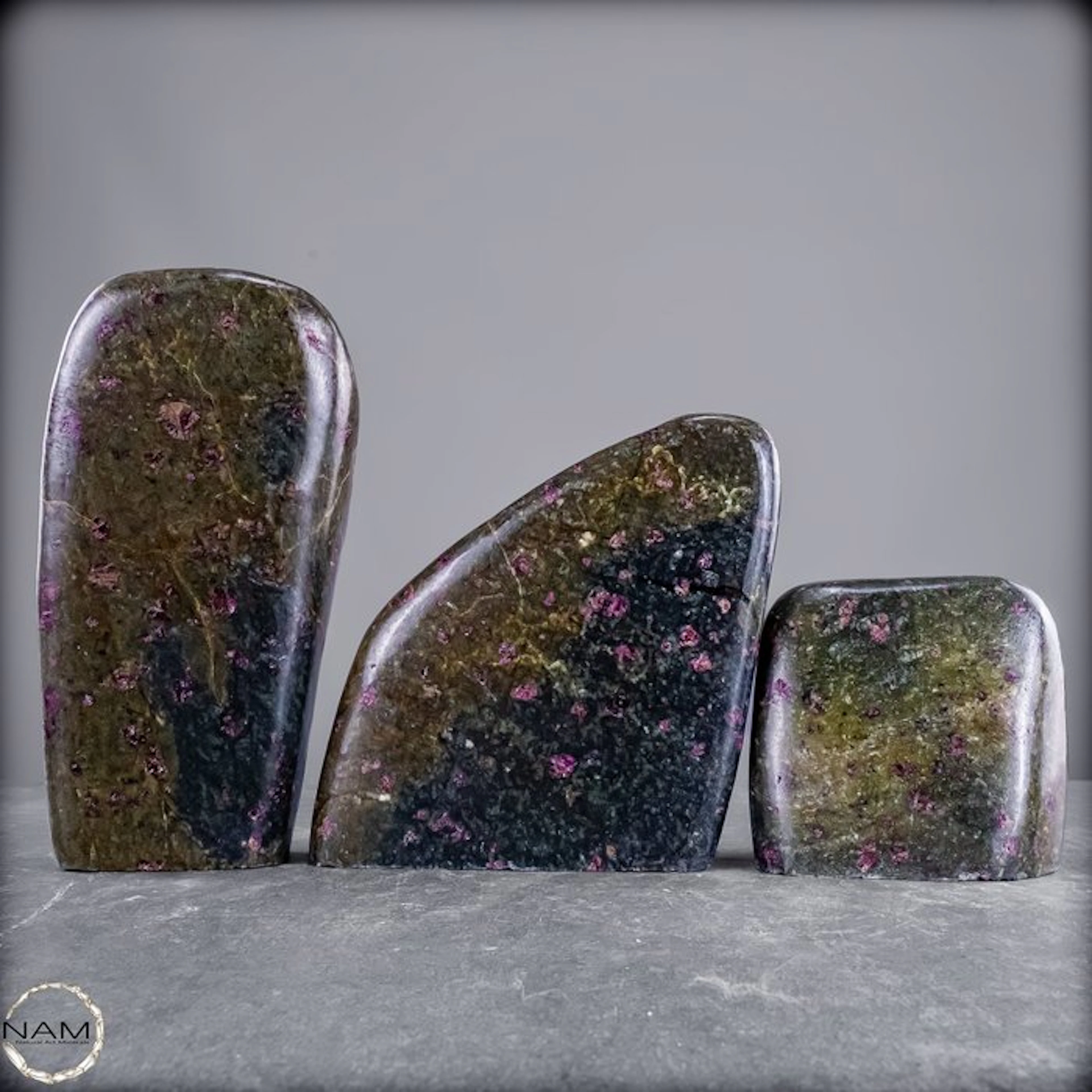 Extraordinary 3-piece almandine garnet set in green...