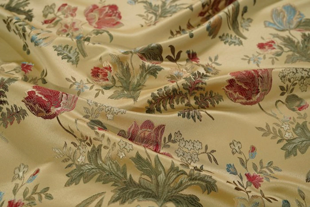 Gold upholstery fabric with floral motifs in classical...