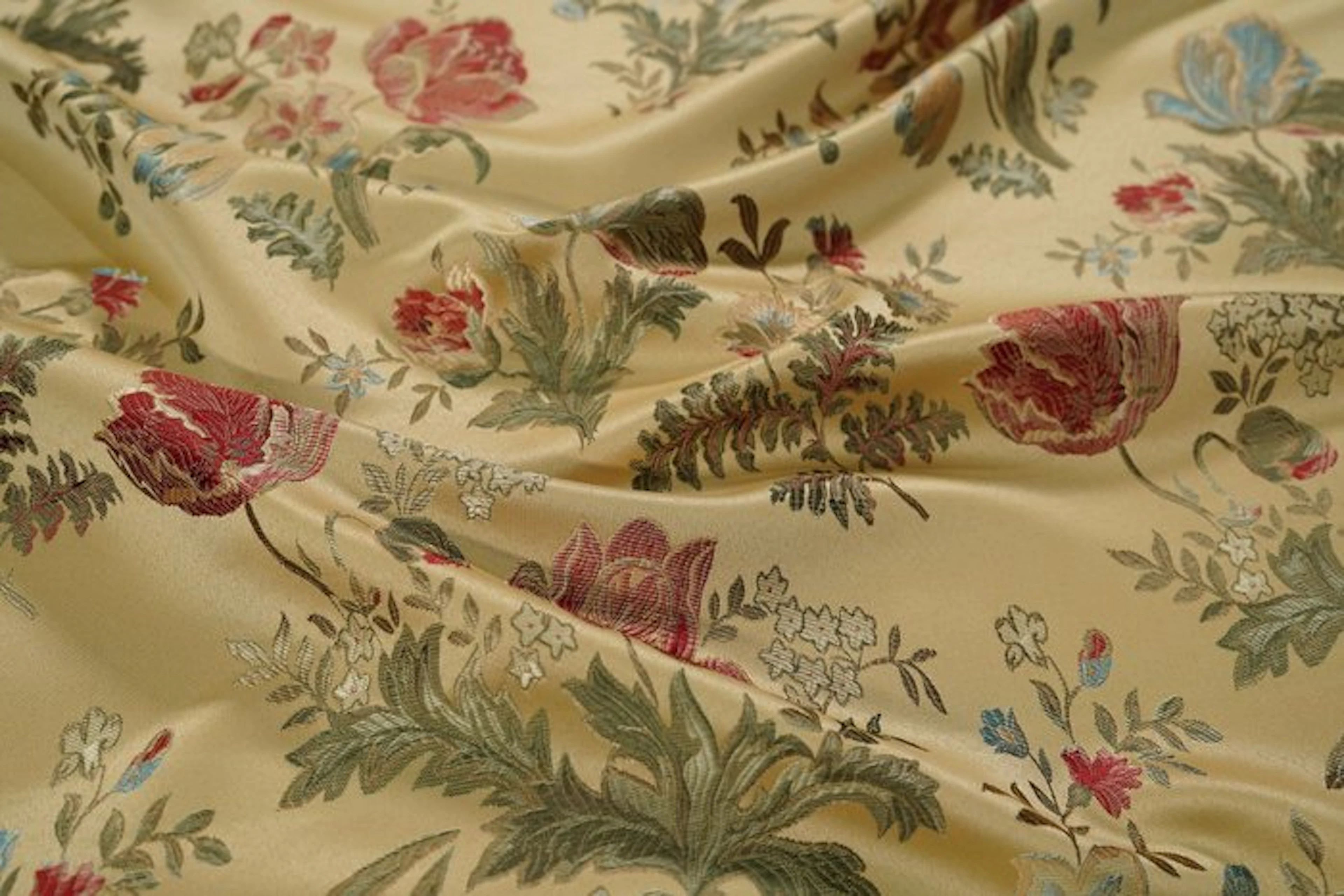 Gold upholstery fabric with floral motifs in classical...