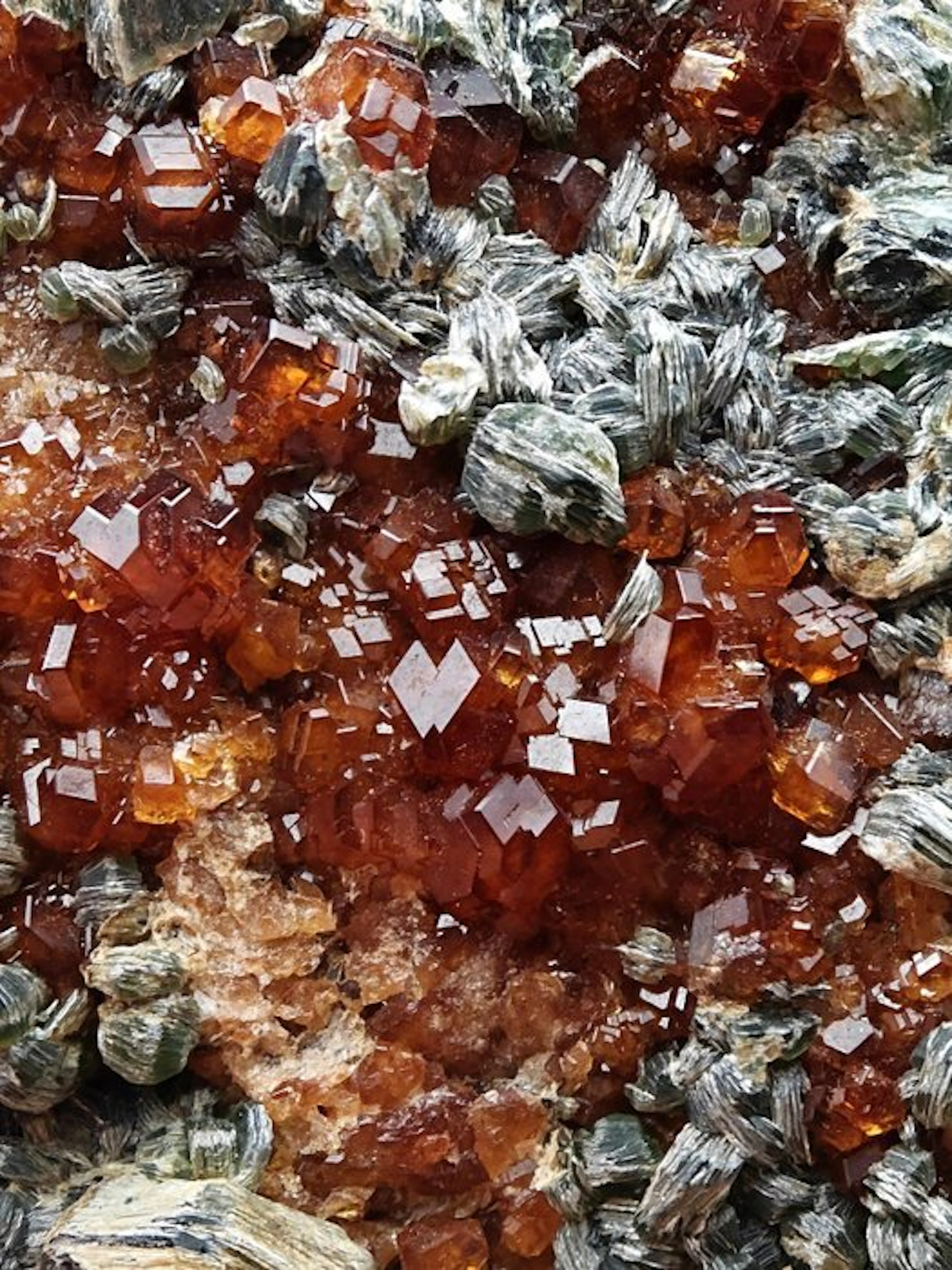 Splendid orange hessonite with green clinochlore