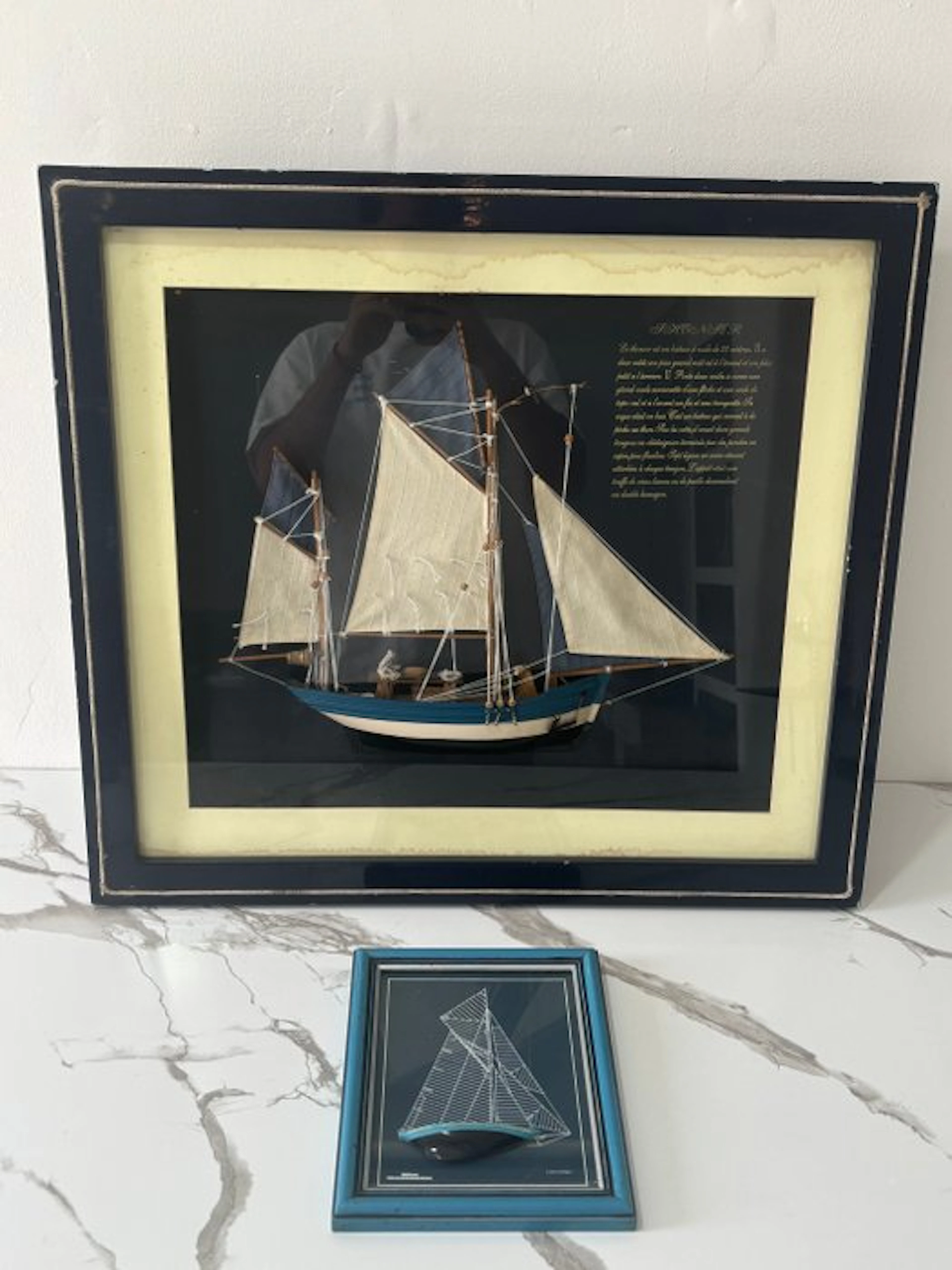 Glazed display frame (2)- Pair of panels with bas-relief...